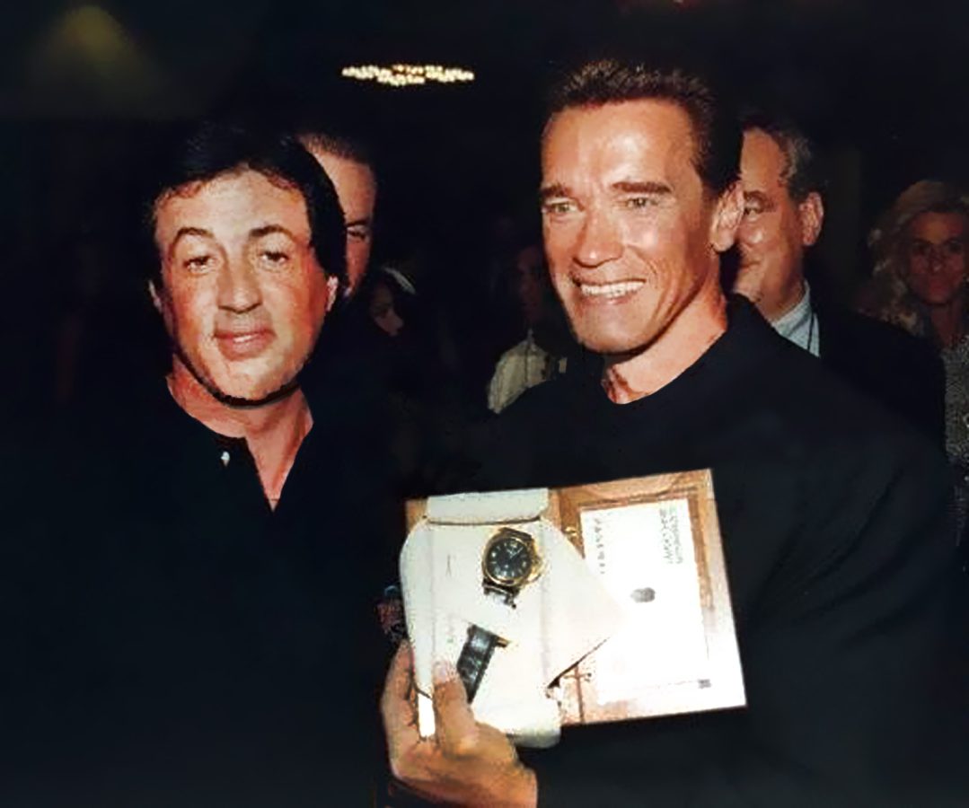 Sylvester Stallone and Arnold Schwarzenegger holding a Sly Tech Panerai watch