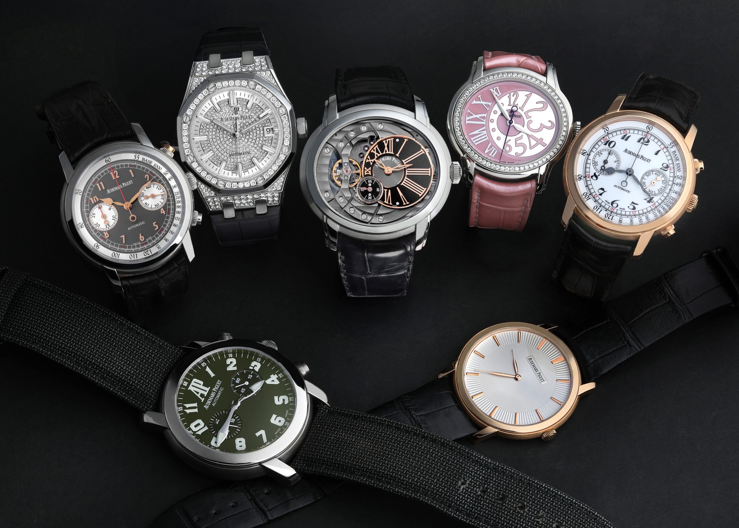 A diverse collection of Audemars Piguet watches showcasing different case shapes including the Royal Oak, Millenary, and Jules Audemars lines.