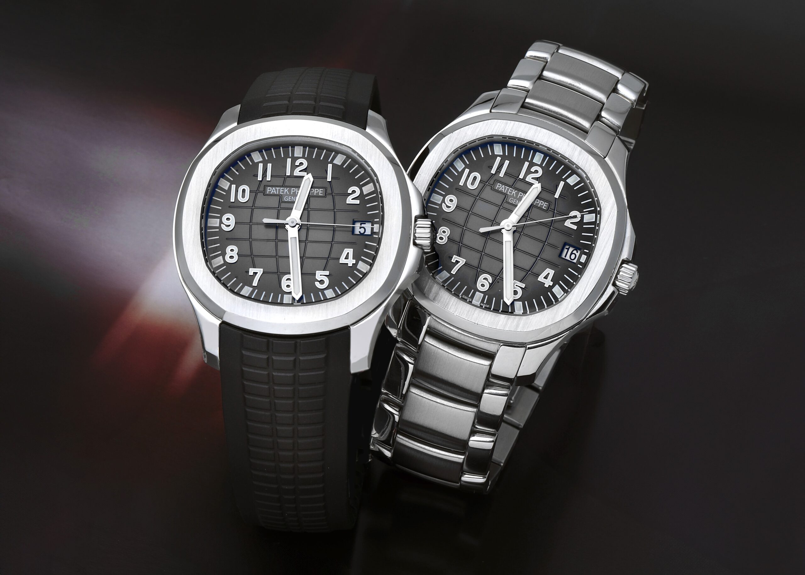 Two Patek Philippe Aquanaut watches reference 5167, one on a black composite rubber strap and one on a stainless steel bracelet.
