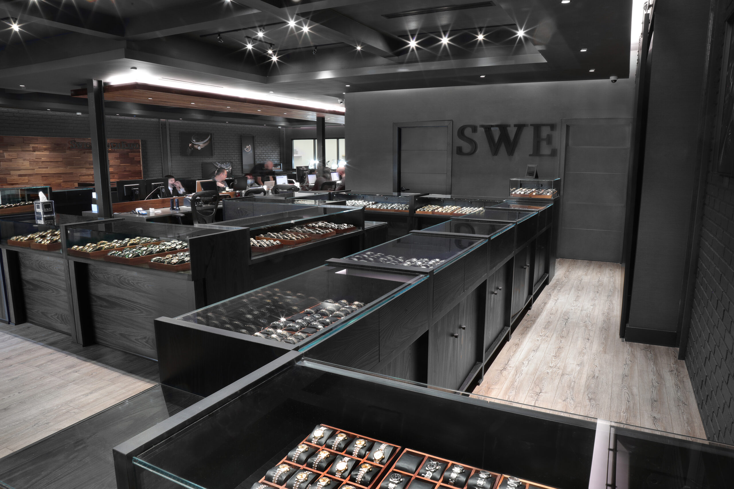 The interior of the SwissWatchExpo showroom featuring multiple display cases filled with luxury watches.