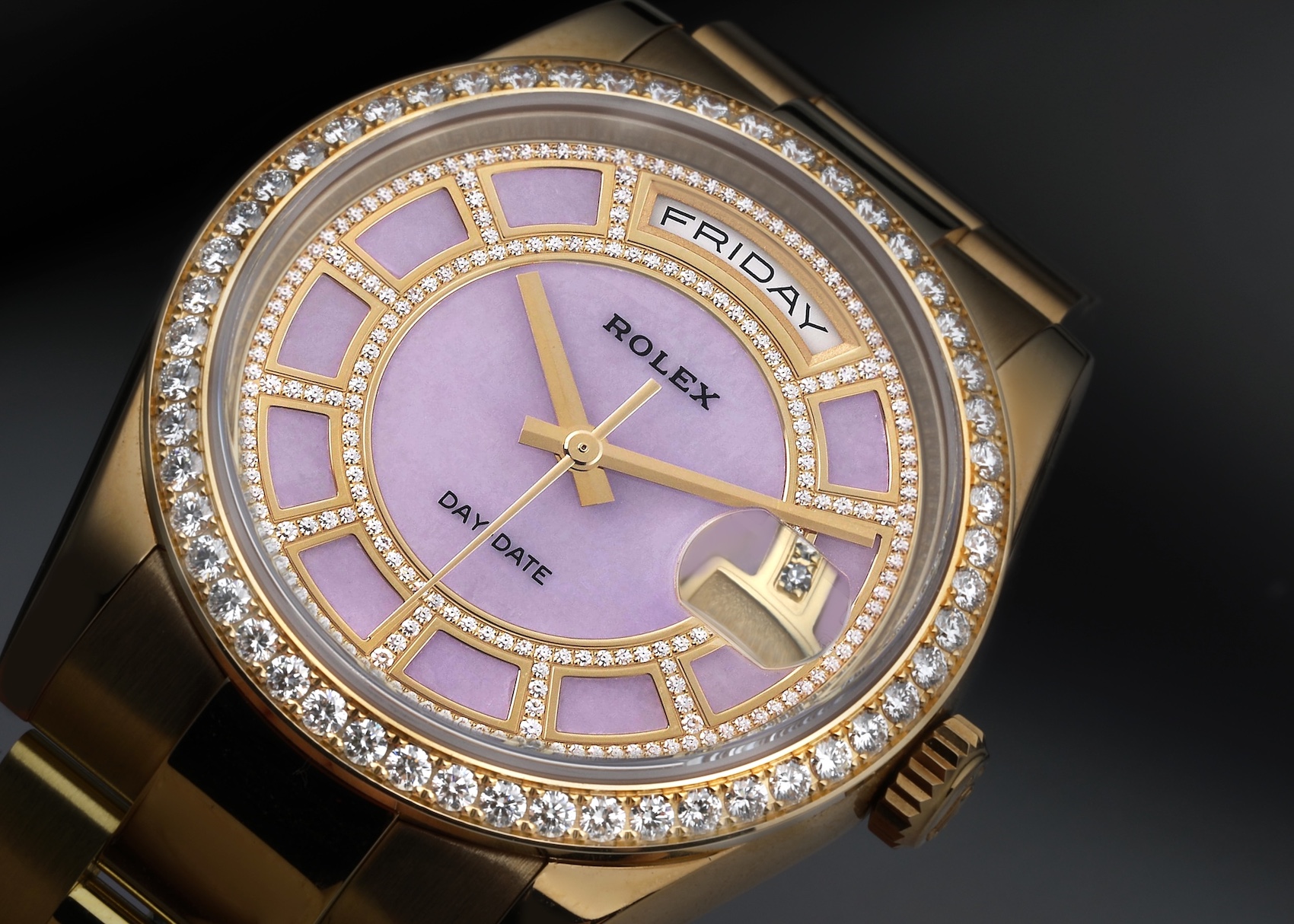 Close-up of a Rolex President Day-Date Yellow Gold Carousel Lilac Jade Diamond Men's Watch 118348, featuring a lilac dial with carousel-style diamond hour markers and a diamond-set bezel.