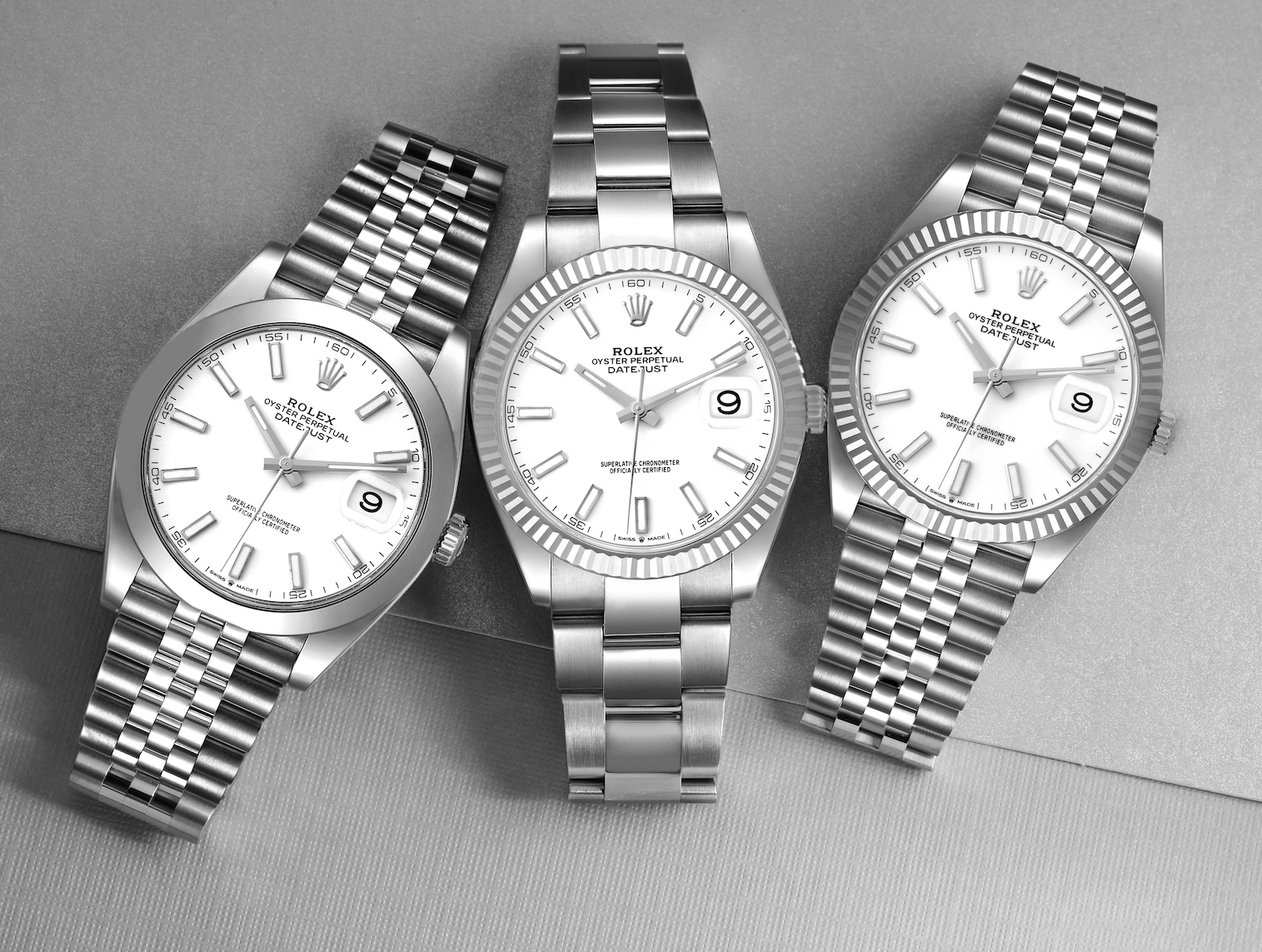 Three different Rolex Datejust 41 watches arranged side-by-side, showcasing various combinations of fluted and smooth bezels with Oyster and Jubilee bracelets.