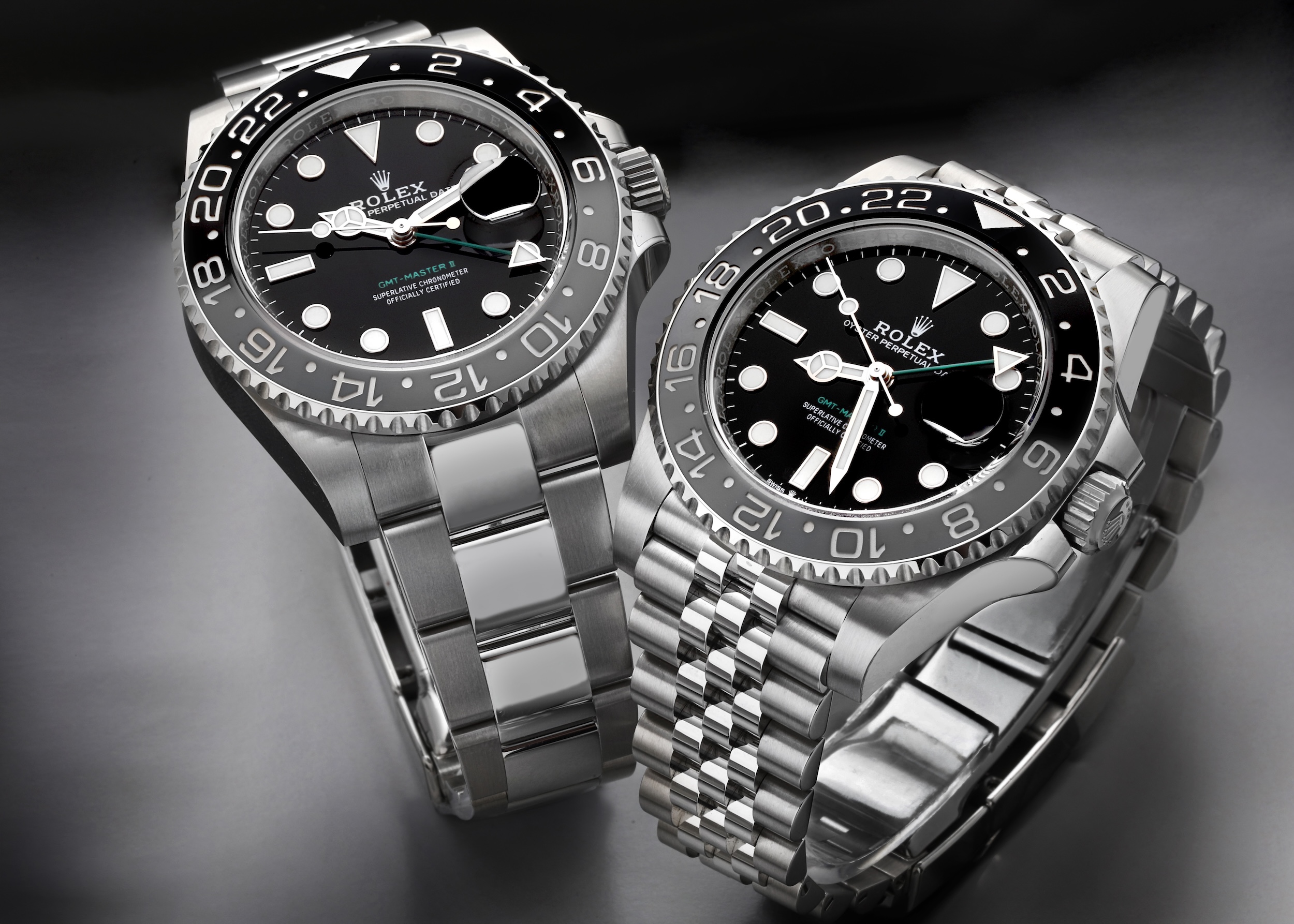 Two Rolex GMT-Master II 'Bruce Wayne' watches, one on an Oyster bracelet and one on a Jubilee bracelet, featuring black and grey Cerachrom bezels.