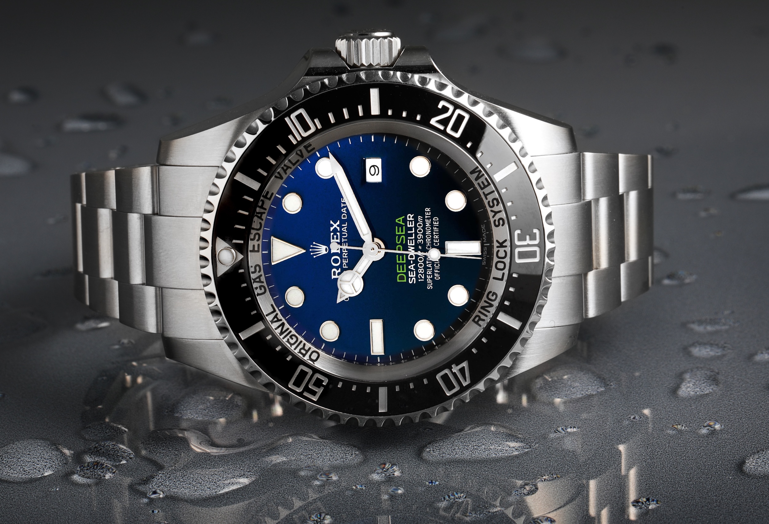 Rolex Deepsea 'Cameron' with its unique D-Blue gradient dial and black ceramic bezel, shown on a wet surface.