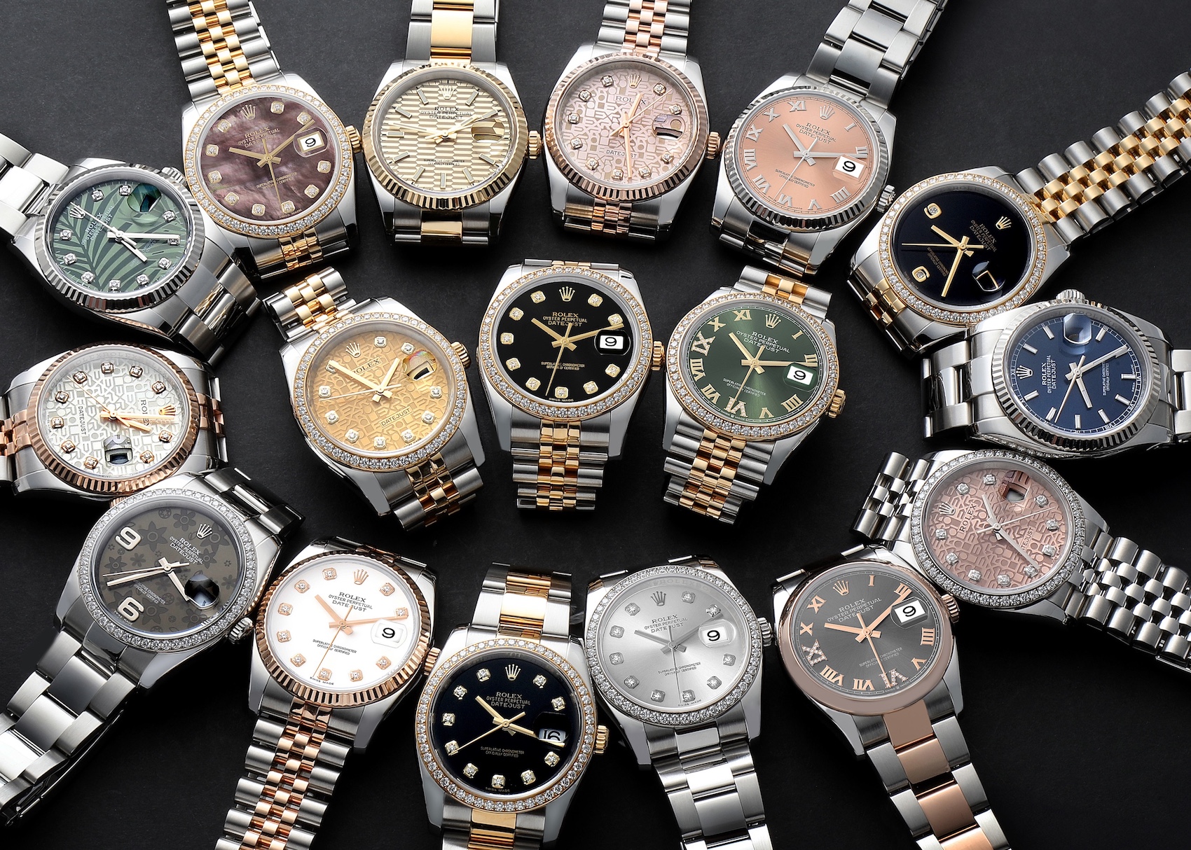 A collection of various Rolex Datejust watches with diamond accents, fluted bezels, and different dial colors and materials, including mother-of-pearl, gold, and patterned.