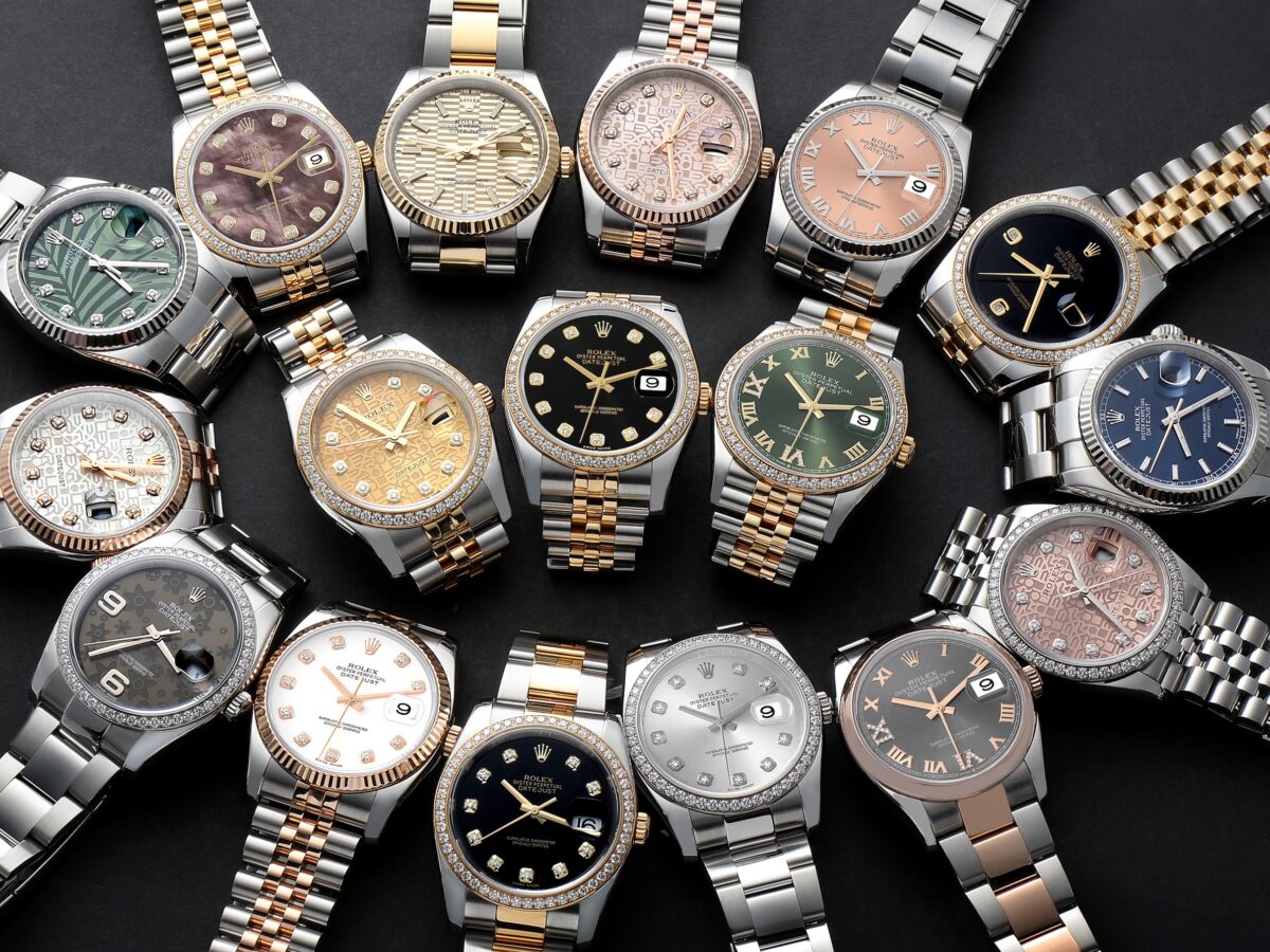 A collection of various Rolex Datejust watches with diamond accents, fluted bezels, and different dial colors and materials, including mother-of-pearl, gold, and patterned.