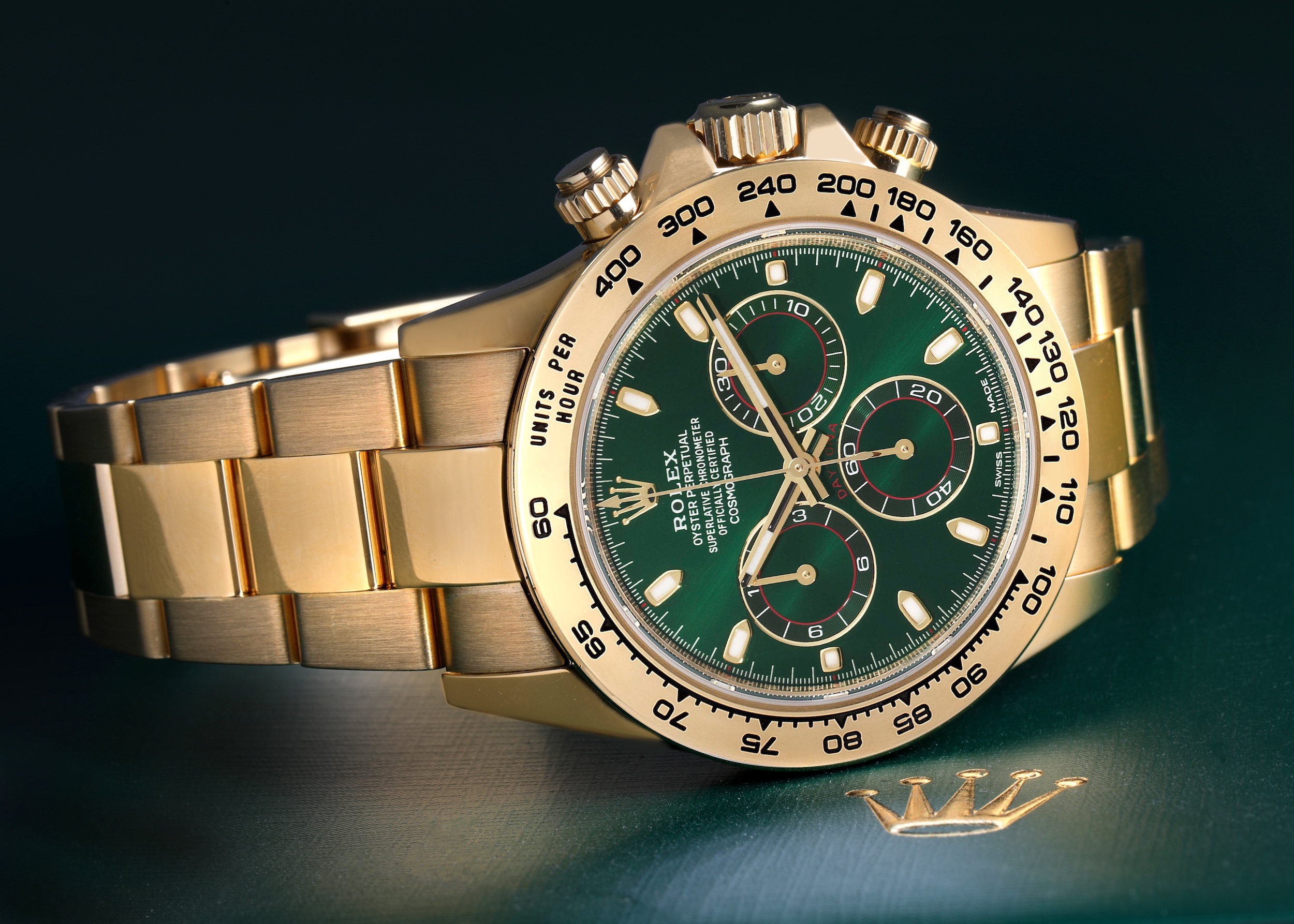 Rolex Daytona in 18k yellow gold with a vibrant green dial and chronograph subdials.