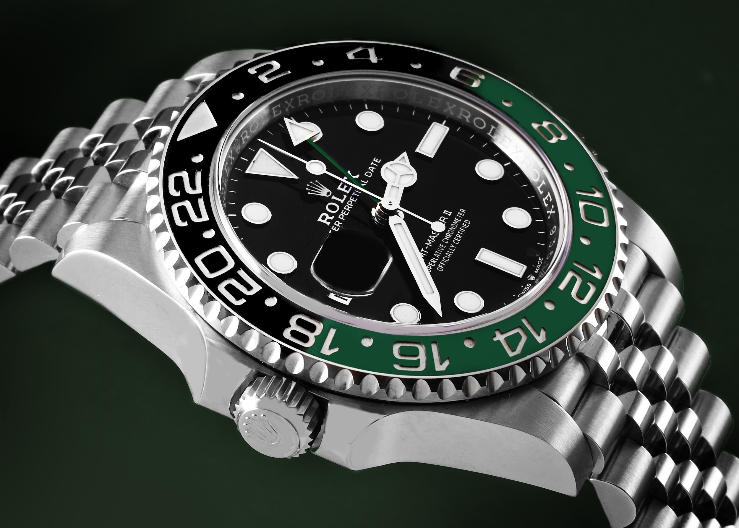 Close-up of the Rolex GMT-Master II 'Sprite' (Ref. 126720VTNR) showing its left-handed crown and black and green ceramic bezel on a Jubilee bracelet.