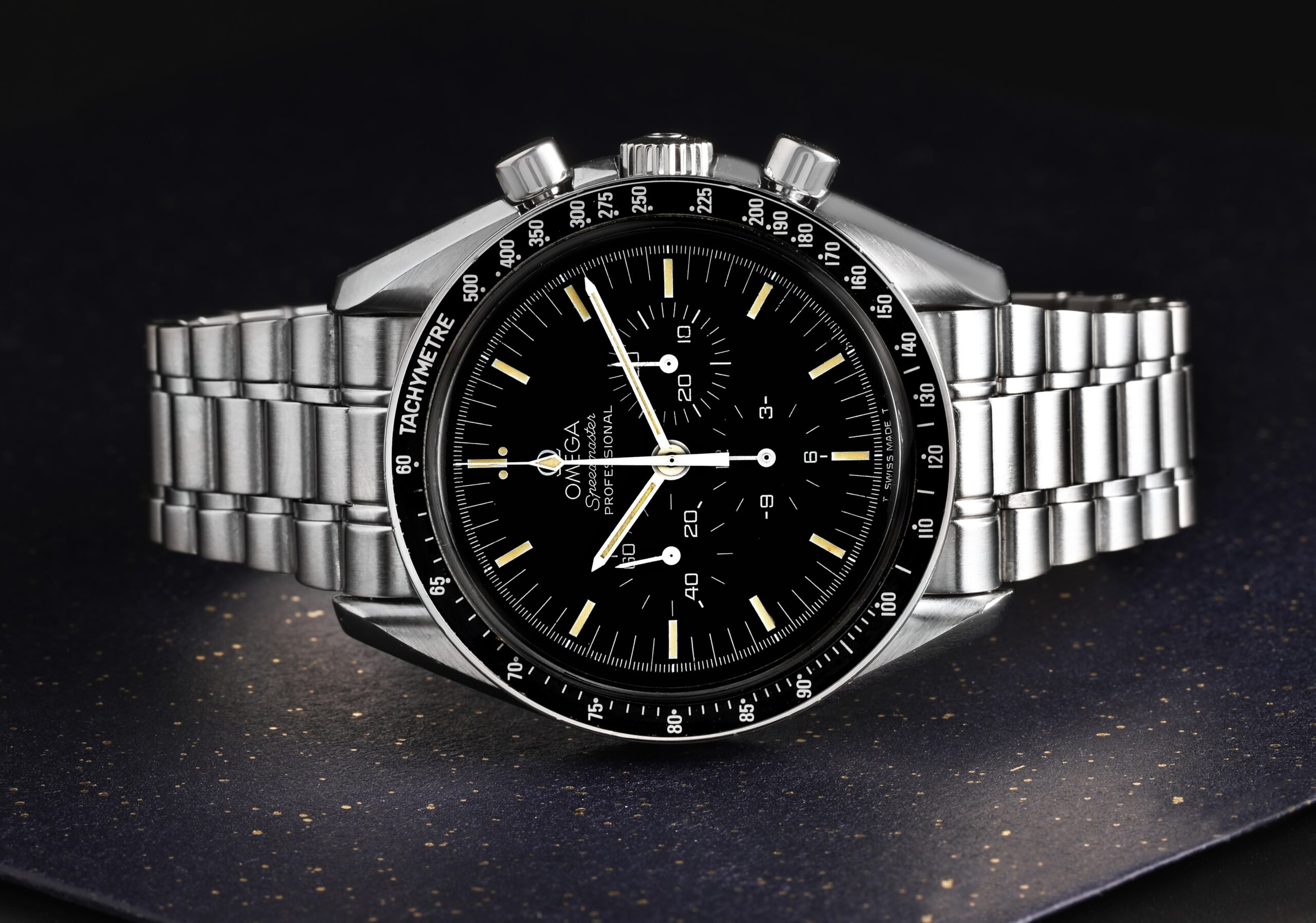 Front view of a vintage Omega Speedmaster Professional Moonwatch, reference 145.022, featuring a black dial and tachymeter bezel on a steel bracelet.