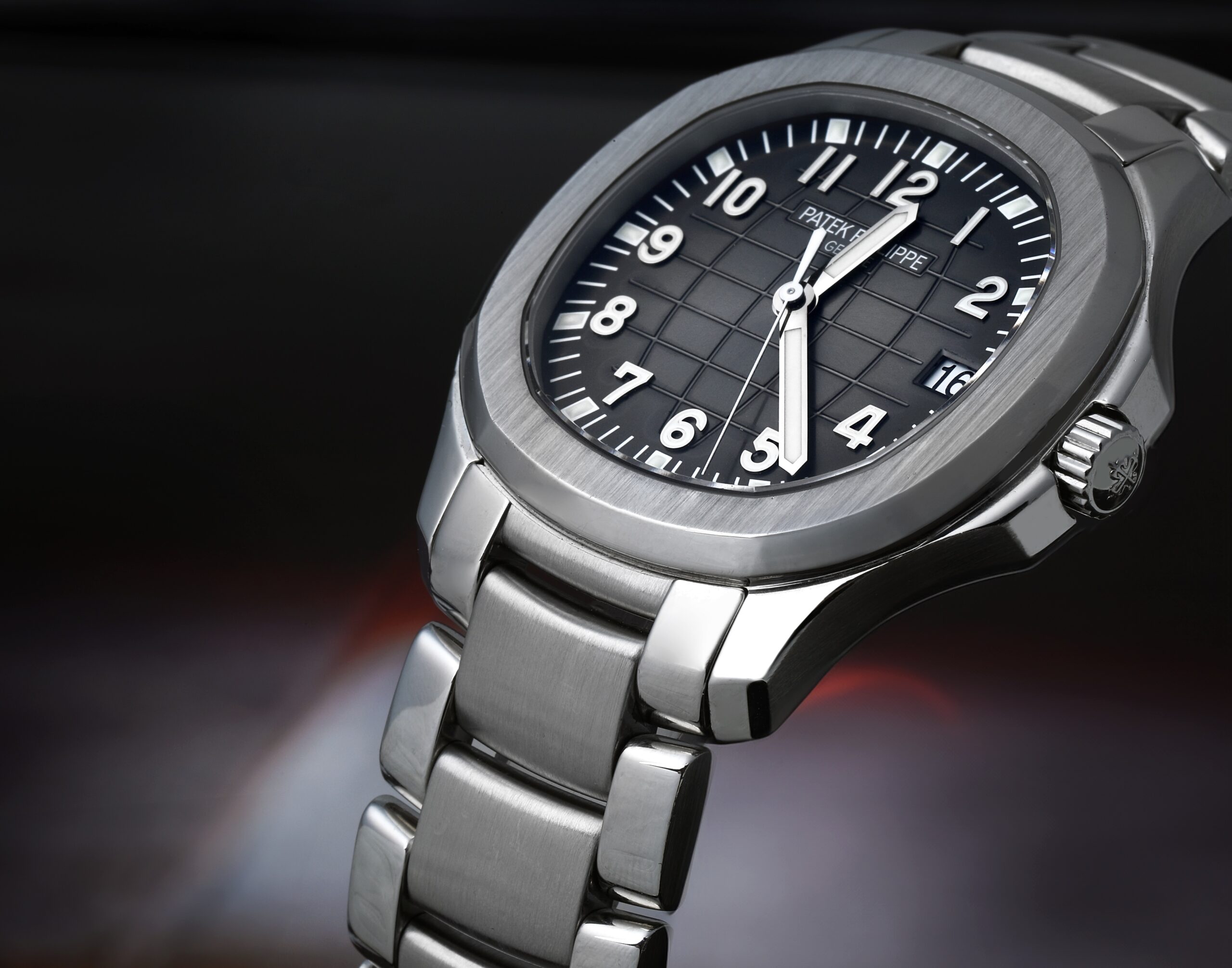 An angled close-up of the Patek Philippe Aquanaut 5167/1A, focusing on its signature rounded octagonal bezel and stainless steel case.