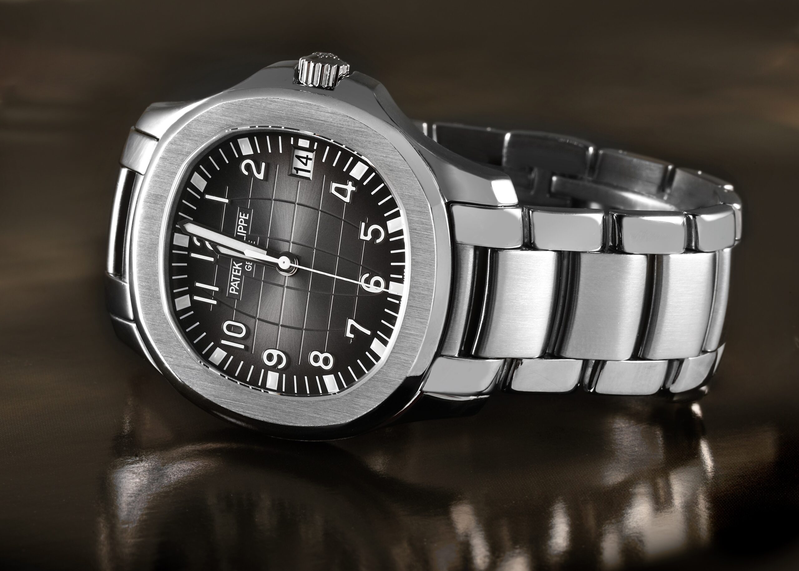 The Patek Philippe Aquanaut 5167/1A watch shown from a side profile, highlighting the design of its engineered stainless steel bracelet.