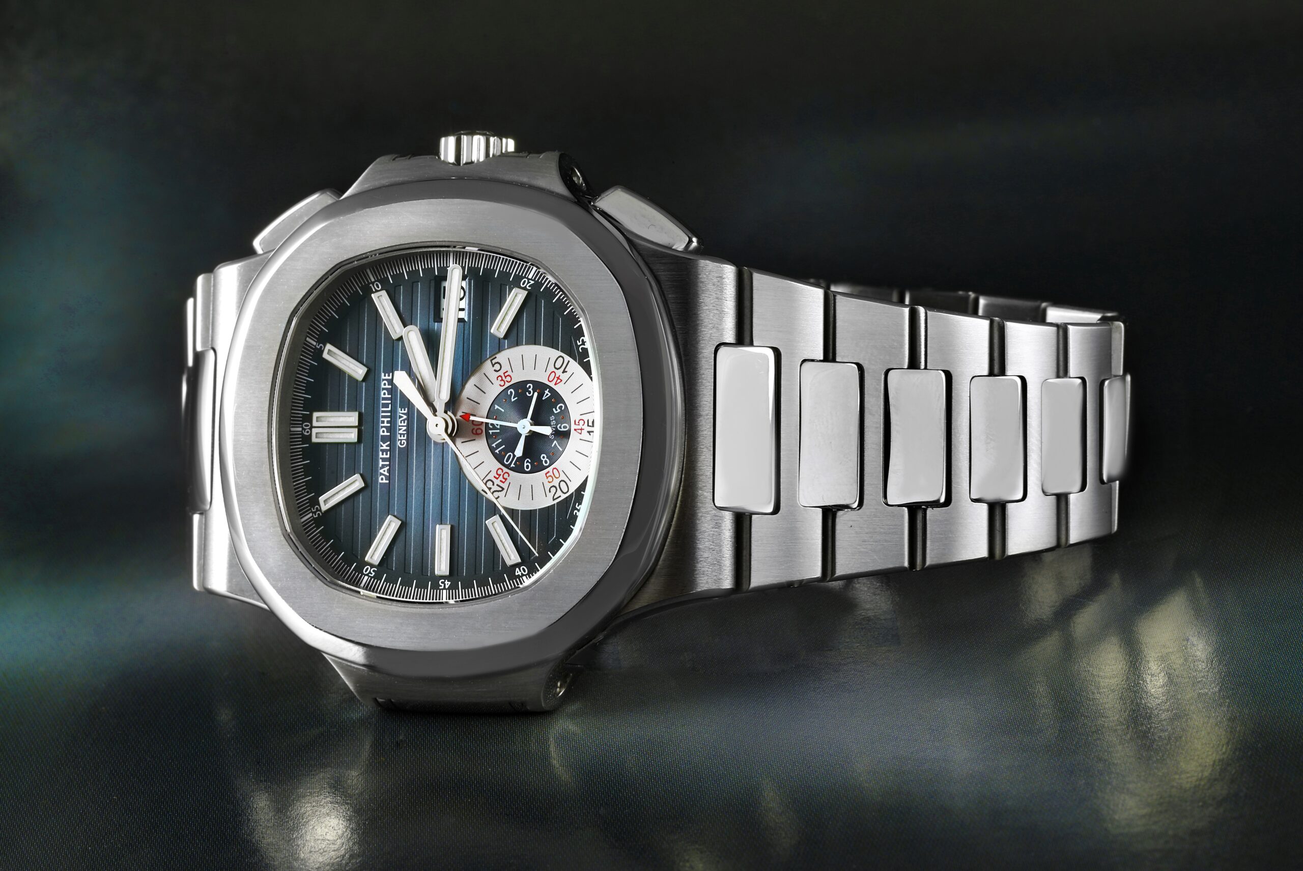 A stainless steel Patek Philippe Nautilus Chronograph 5980 with its integrated bracelet and blue dial.