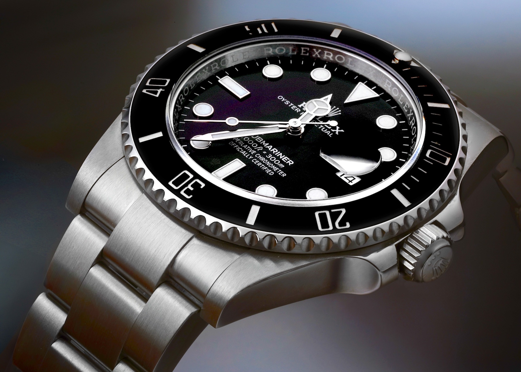 A Rolex Submariner watch is shown, highlighting its iconic design with a black dial and a unidirectional rotating bezel, set against a polished stainless steel Oyster bracelet.