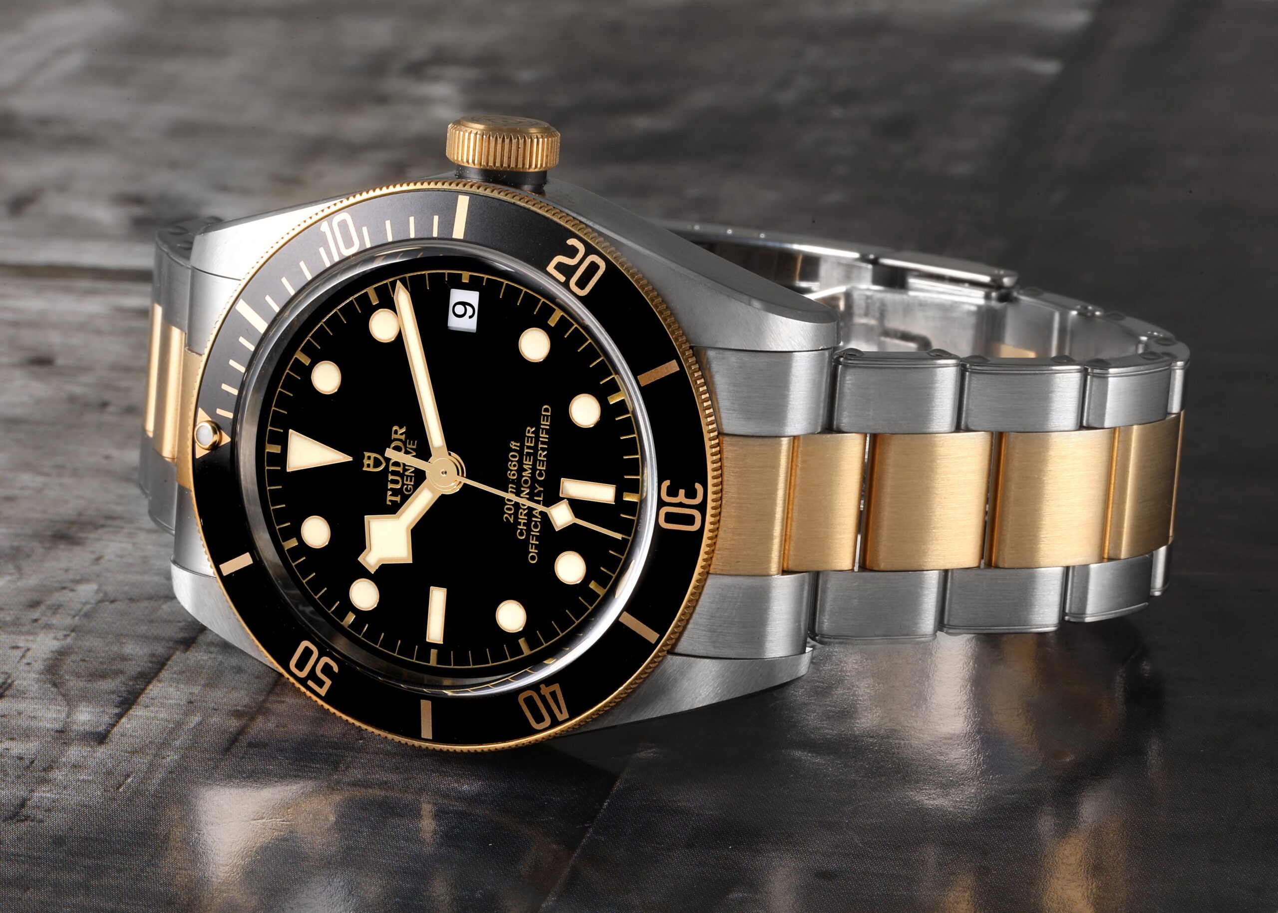 A two-tone Tudor Black Bay 79733 in steel and yellow gold, showing its iconic 'snowflake' hands and black dive bezel.