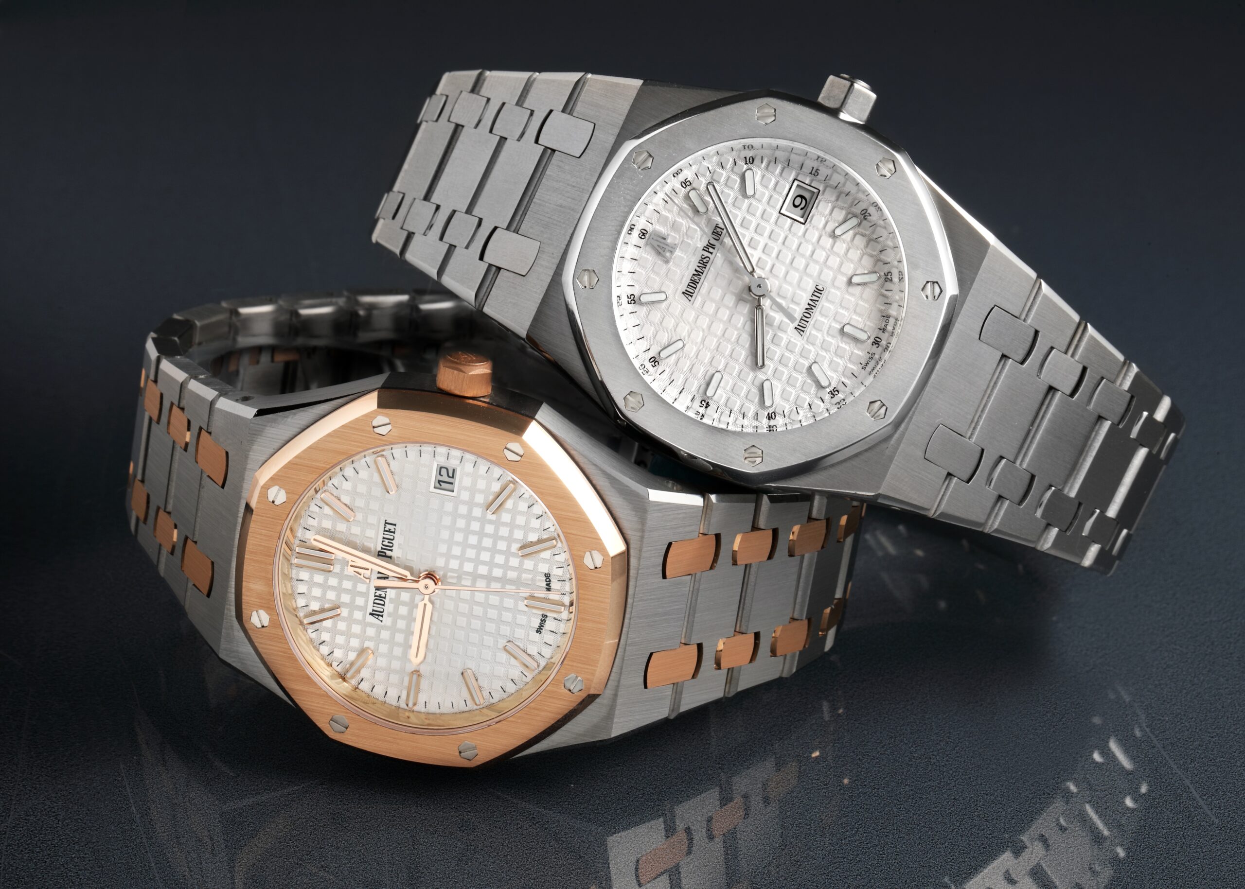 Two Audemars Piguet Royal Oak watches, one in steel and rose gold and the other in all steel, showcasing the model's versatile design.