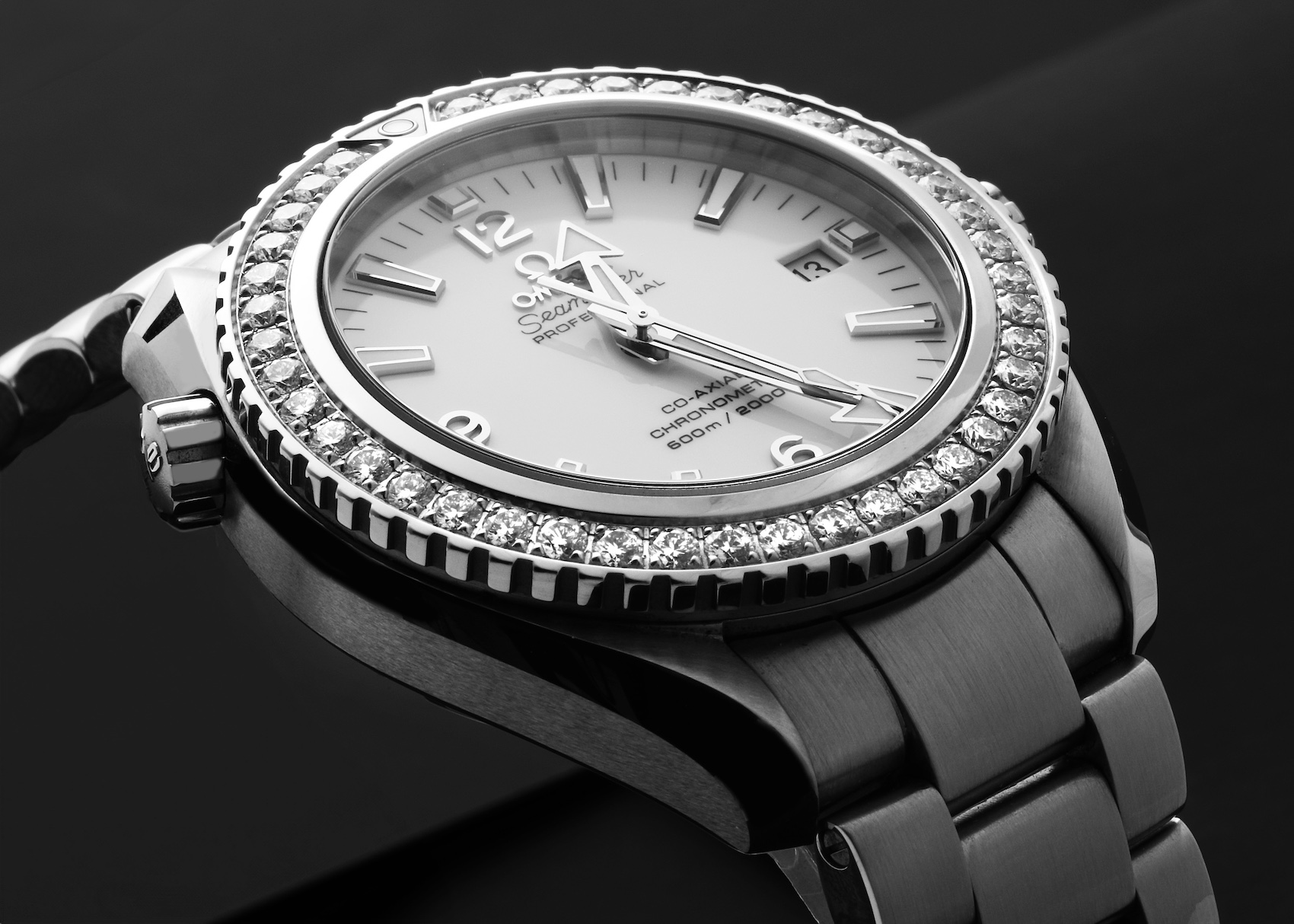 A photograph of the Omega Seamaster Planet Ocean, showcasing its robust steel case, a brilliant diamond-set diving bezel, and a highly legible dial.