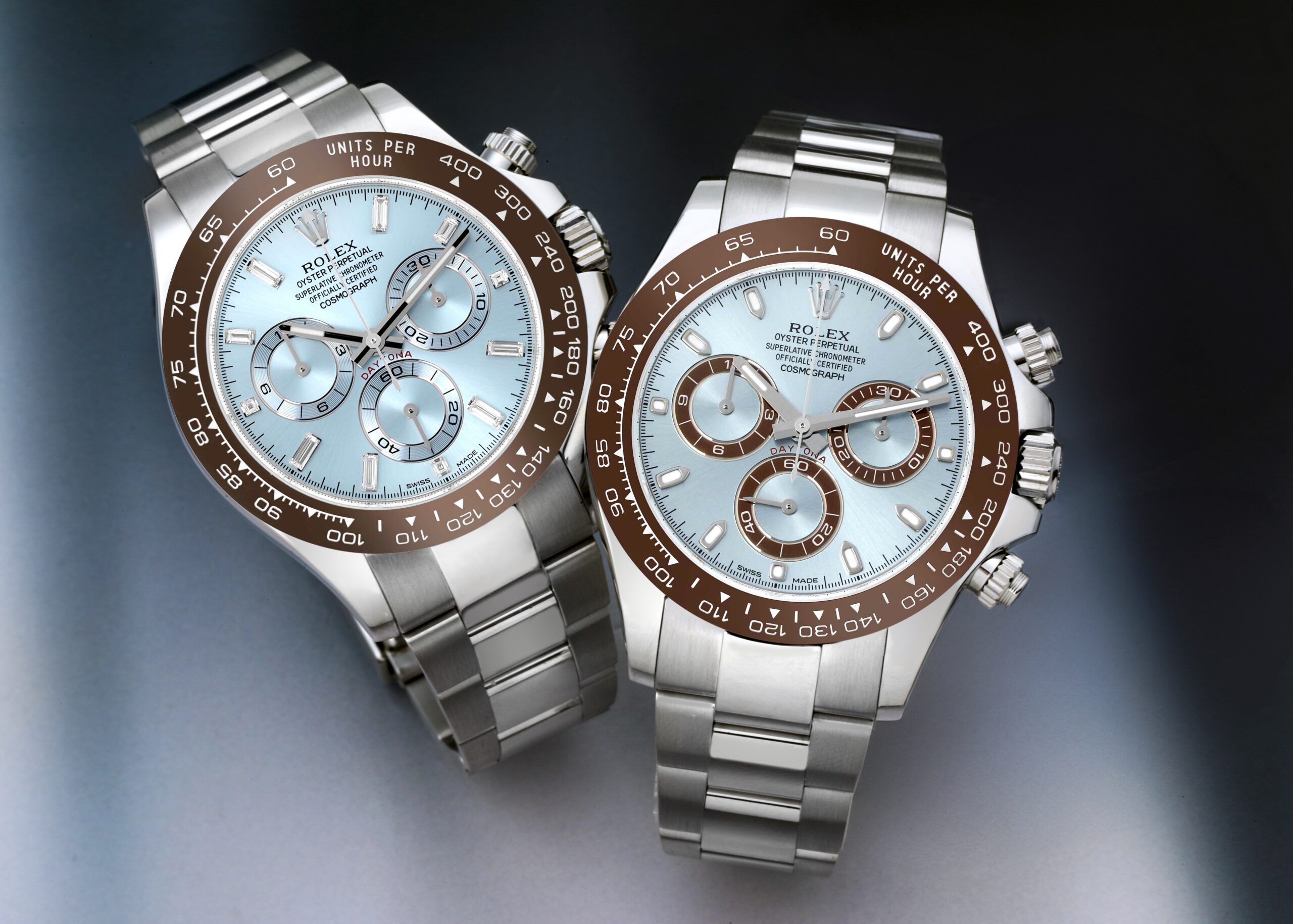 Two Rolex Cosmograph Daytona watches in platinum, featuring ice blue dials and brown ceramic bezels.