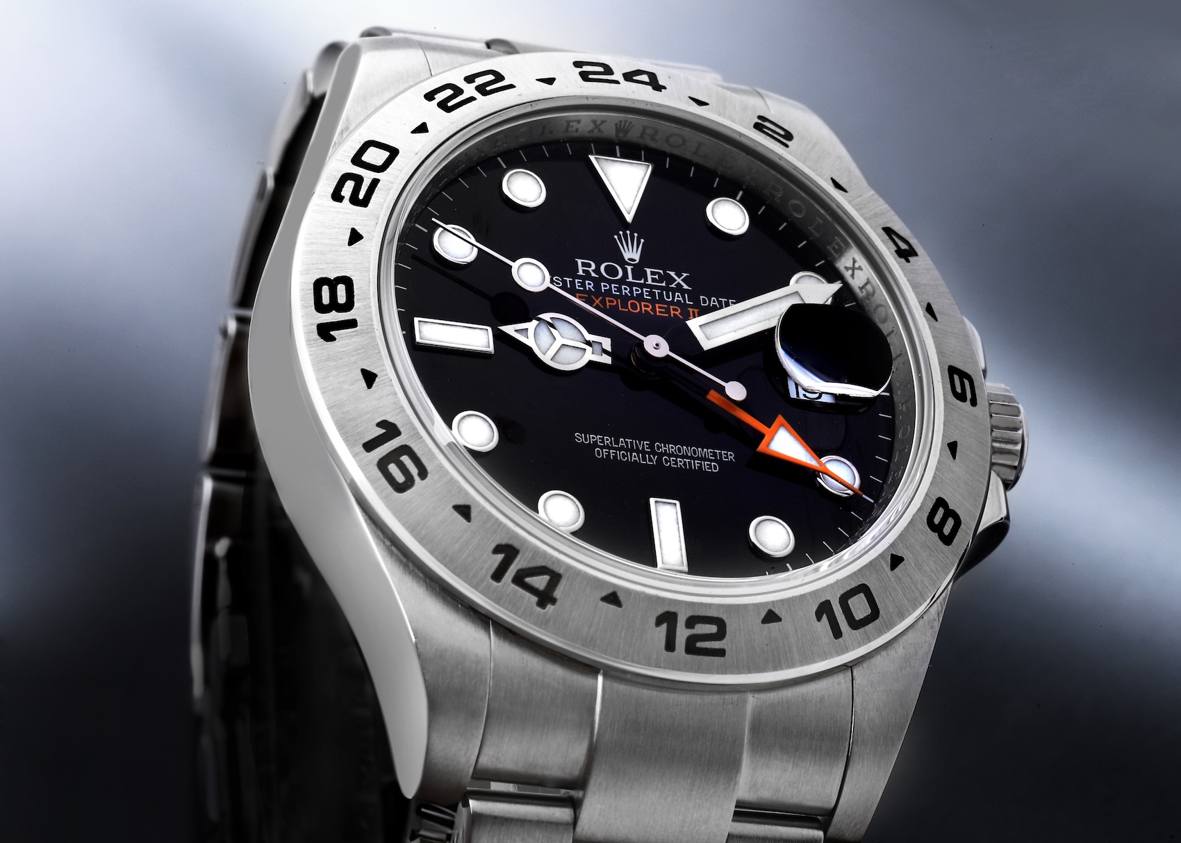 A close-up, angled shot of the modern Rolex Explorer II 226570, focusing on its fixed 24-hour bezel, black dial, and signature orange GMT hand.