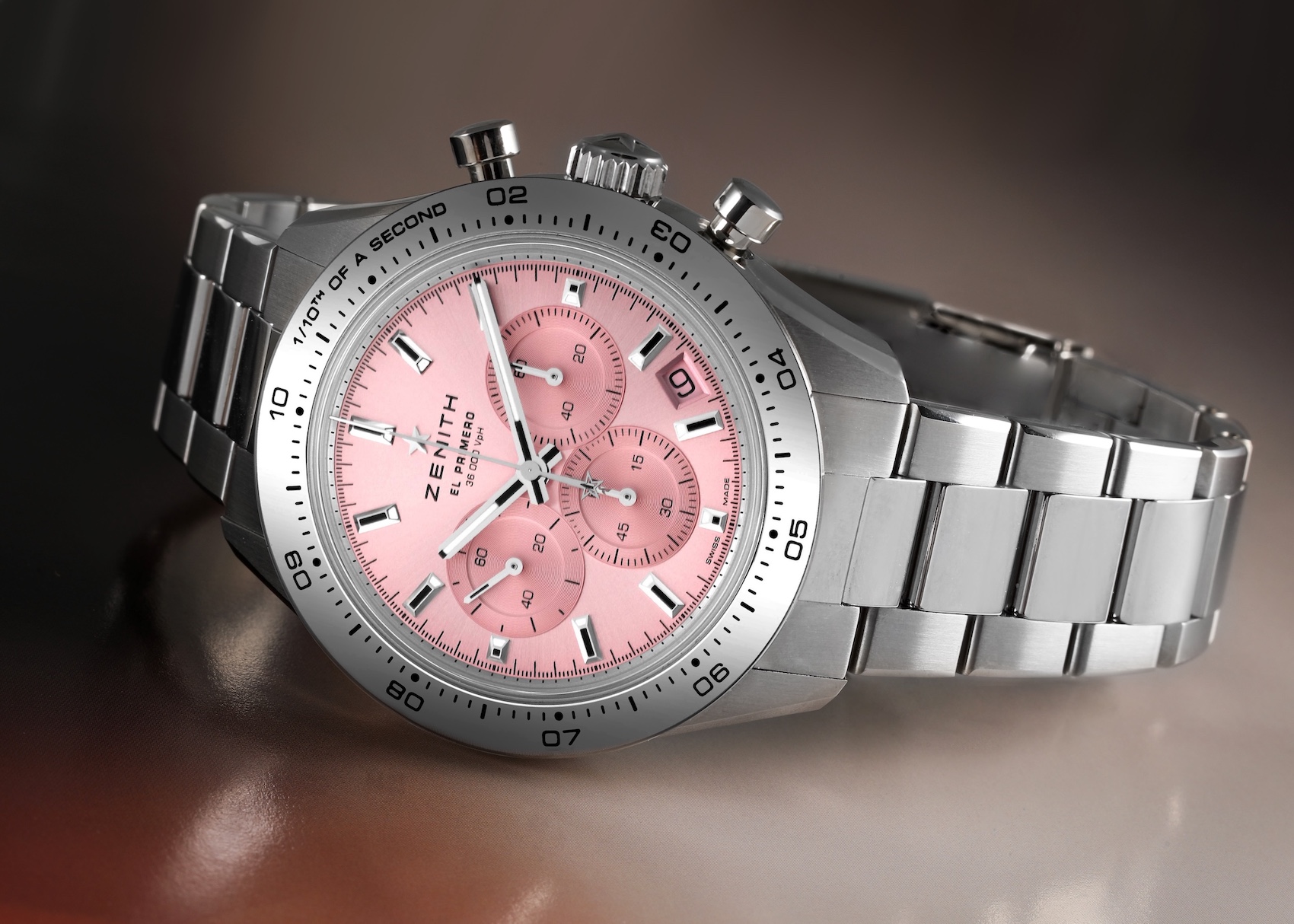 The Zenith Chronomaster Sport chronograph watch, featuring a stainless steel case, a metallic pink dial with tri-color subdials, and a steel bracelet.