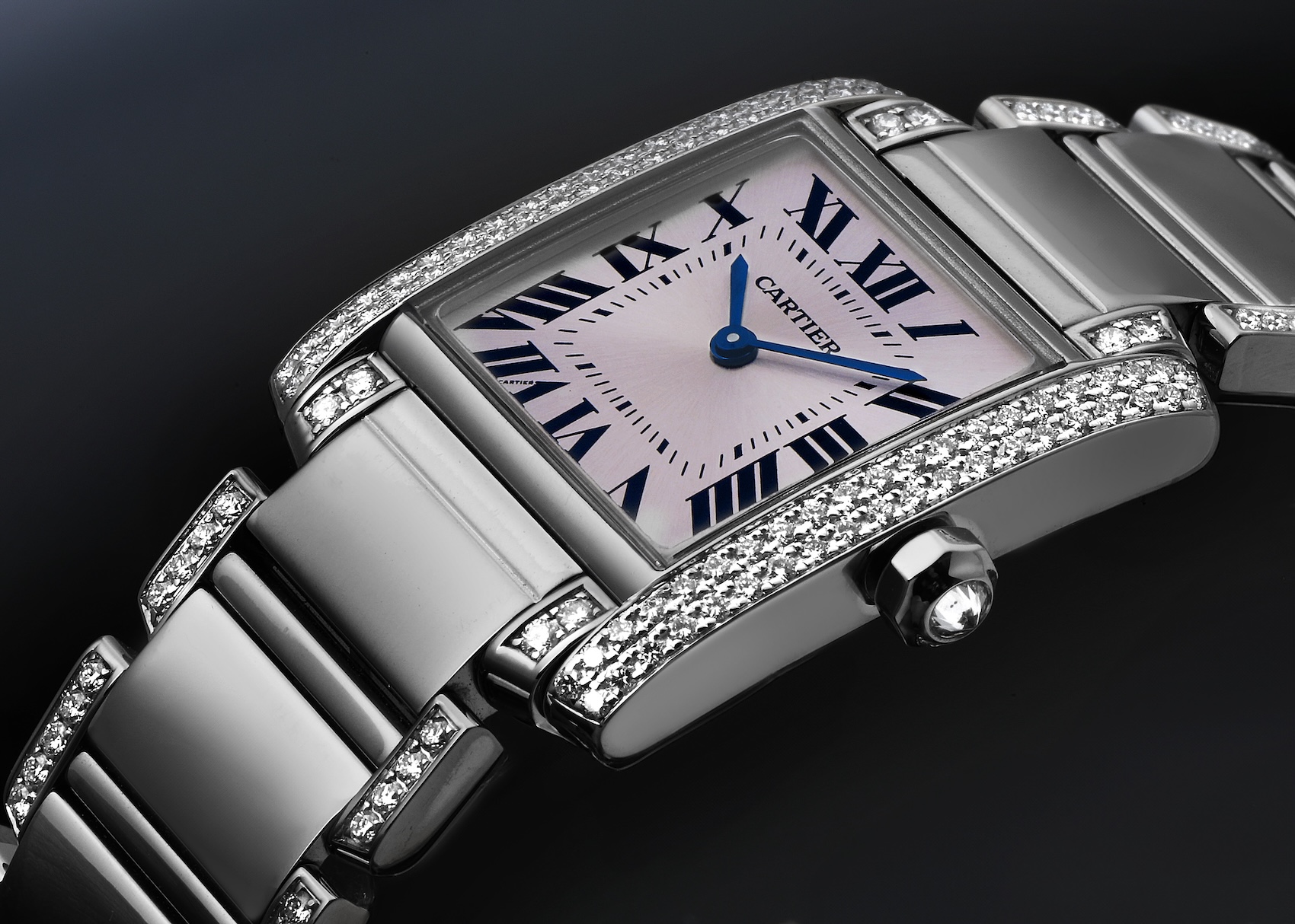 A close-up of the Cartier Tank Française WE1014SC in white gold, highlighting the diamonds set along the brancards (vertical case sides) and its classic Roman numeral dial.