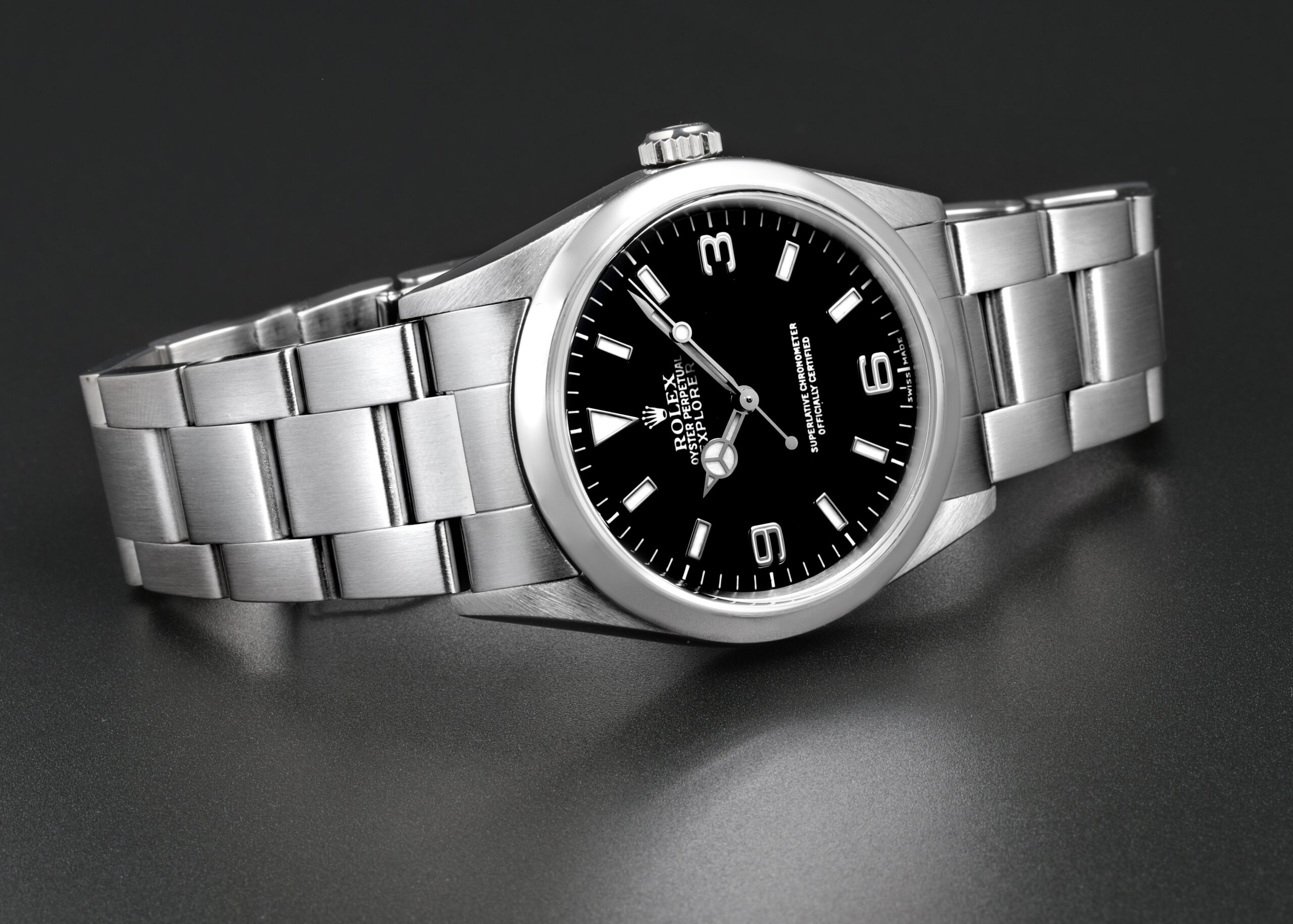 Rolex Explorer I 36mm with a black dial, 3-6-9 numerals, and Oyster bracelet.