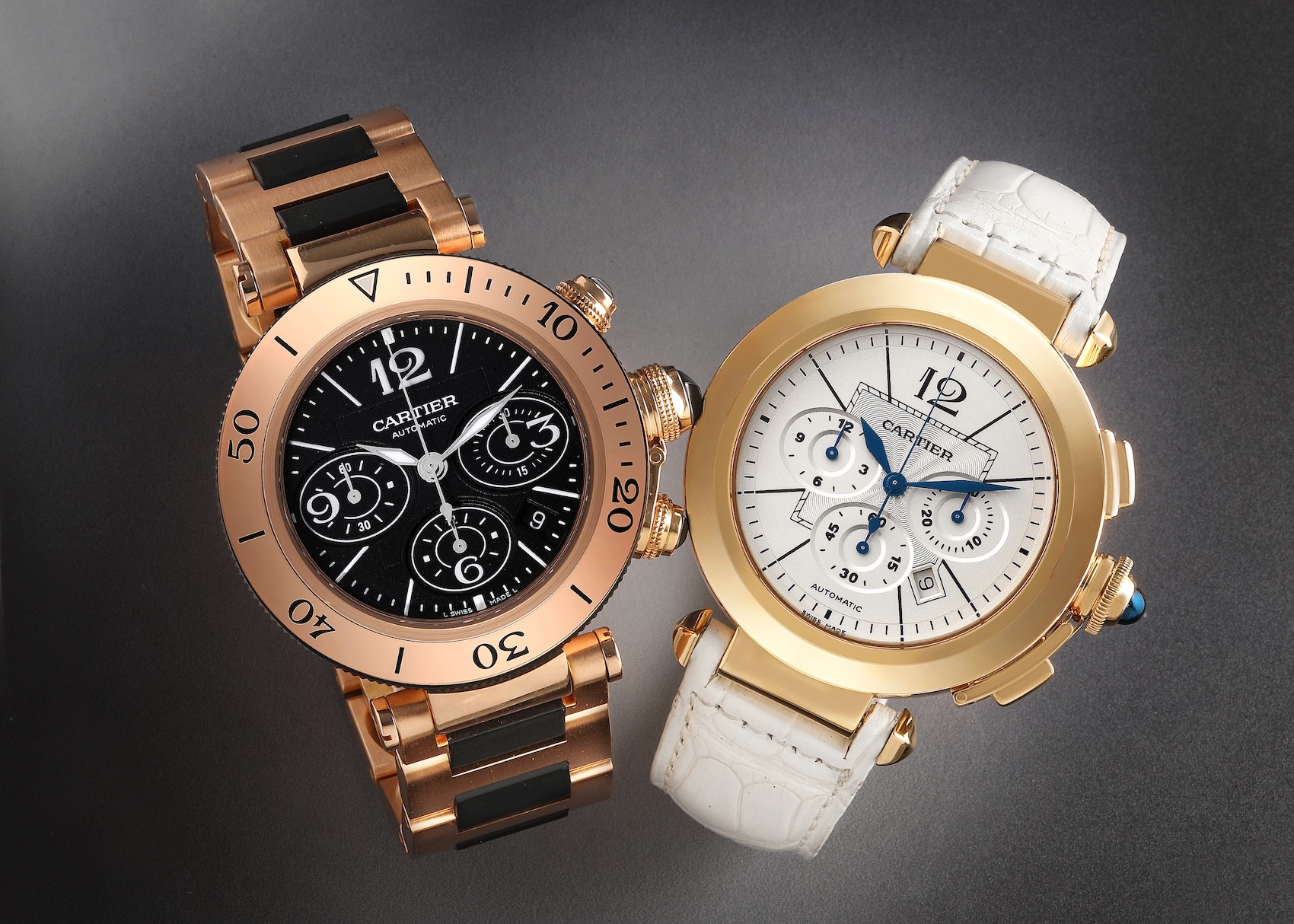 A side-by-side comparison of two Cartier Pasha chronograph watches. On the left, a rose gold and black ceramic Pasha Seatimer. On the right, a yellow gold Pasha with a white dial and white alligator strap.