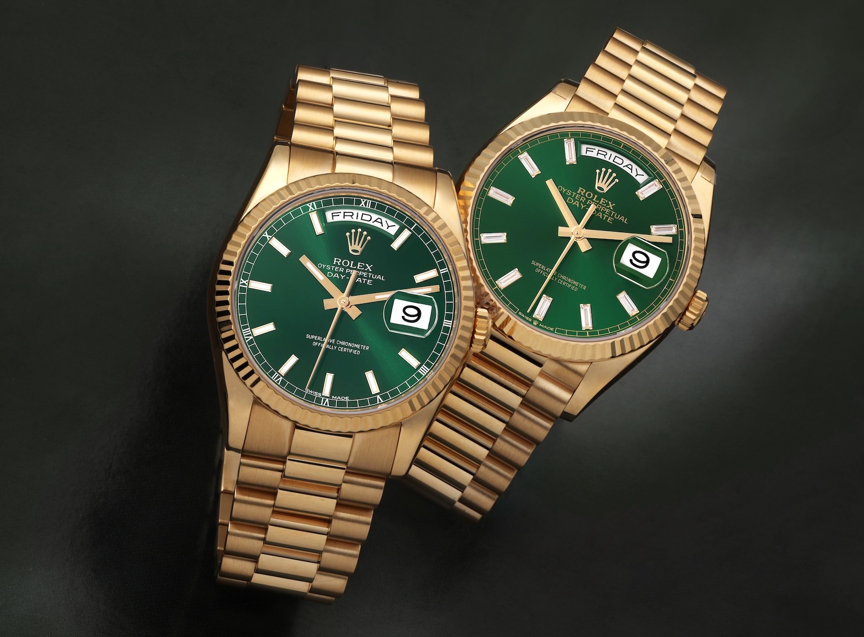 Two Rolex Day-Date 36 "President" watches in 18k yellow gold, both featuring vibrant green dials, one with Roman numerals and the other with stick indices.