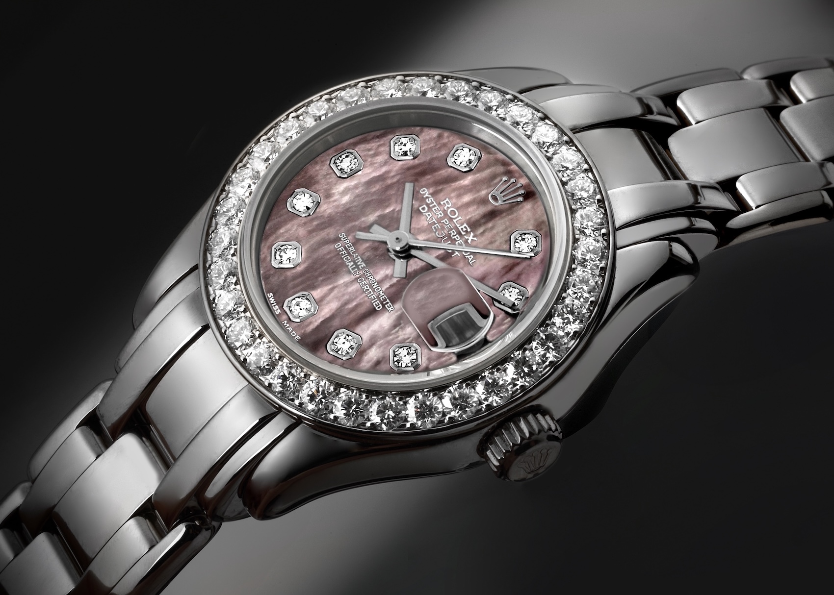 A Rolex Lady-Datejust Pearlmaster watch in white gold, featuring a diamond-set bezel, a purple mother-of-pearl dial with diamond hour markers, and the signature Pearlmaster bracelet.