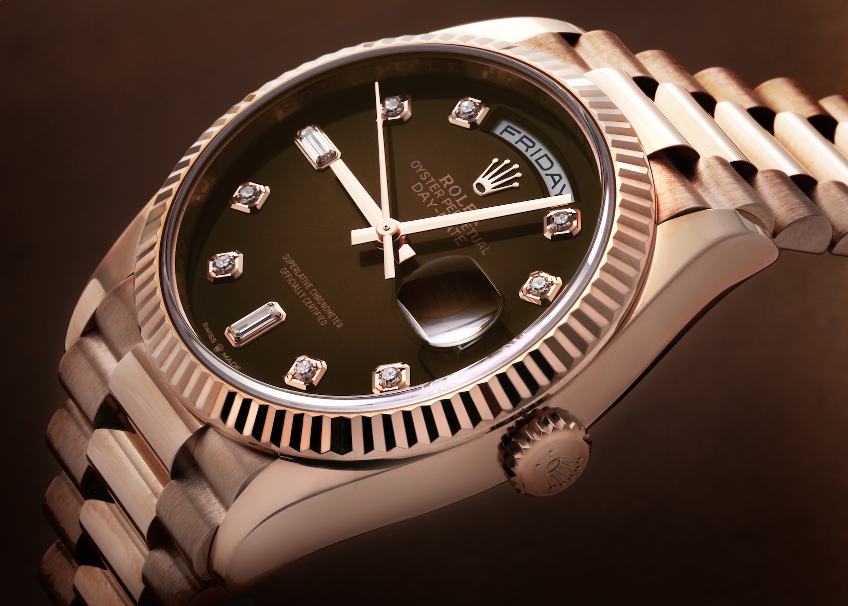 A luxury Rolex Day-Date 'President' in 18k rose gold, shown with a fluted bezel, President bracelet, and a chocolate brown dial adorned with diamond hour markers.