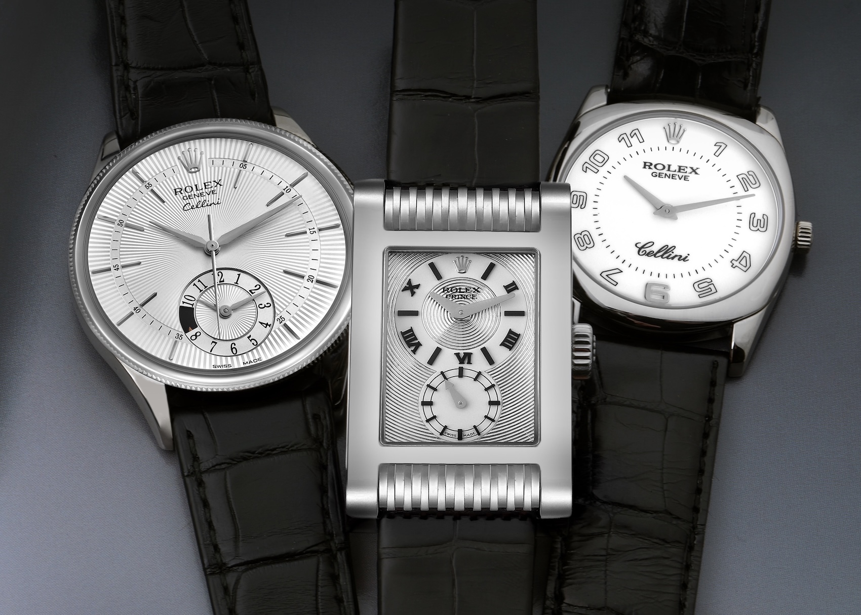 A collection of three Rolex Cellini dress watches in white gold with black leather straps, shown side-by-side: a Cellini Date, a rectangular Cellini Prince, and a cushion-cased Cellini Danaos.