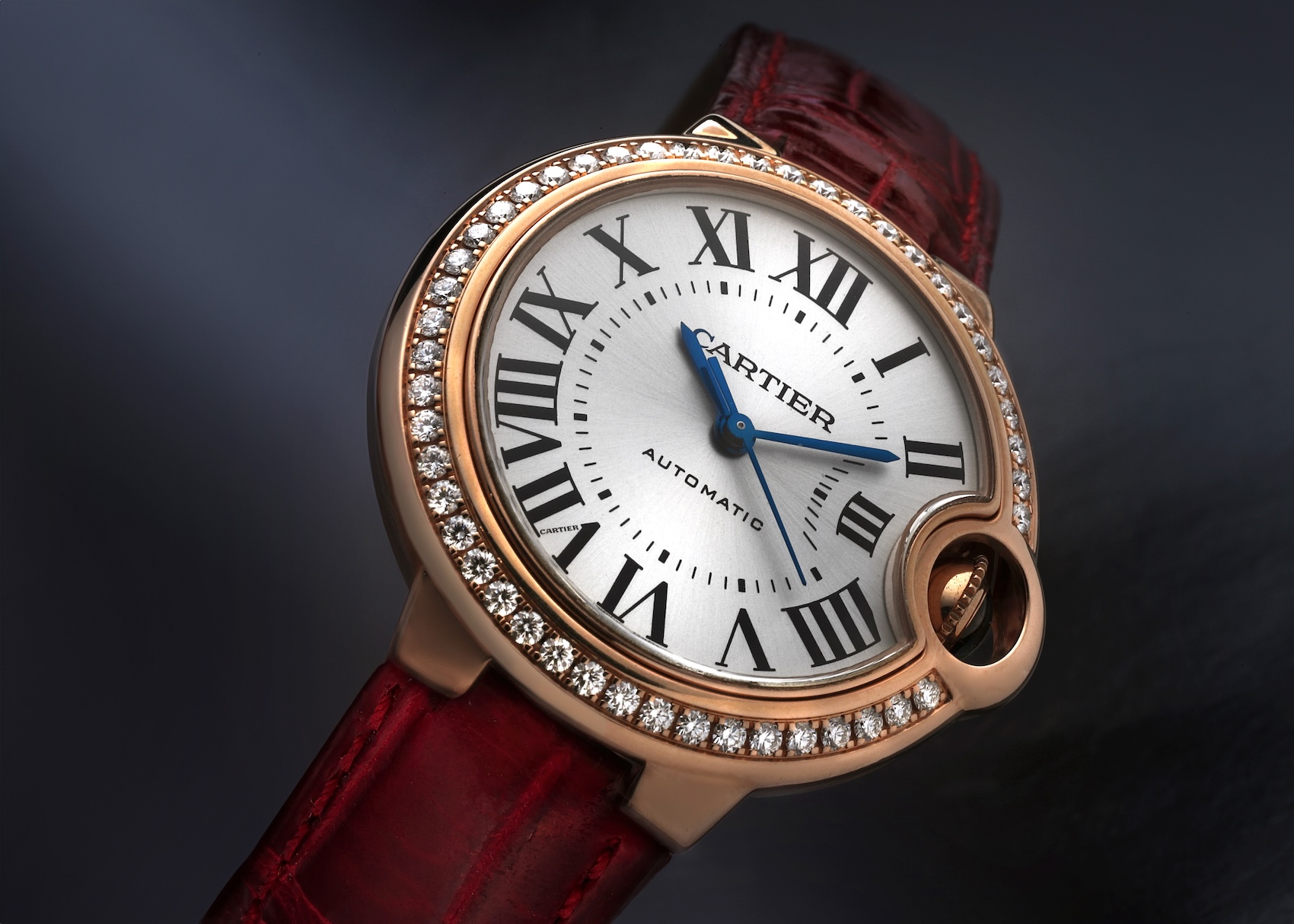 Cartier Ballon Bleu 33mm watch in 18k Rose Gold with a factory diamond bezel and red alligator leather strap (Ref. WJBB0033).