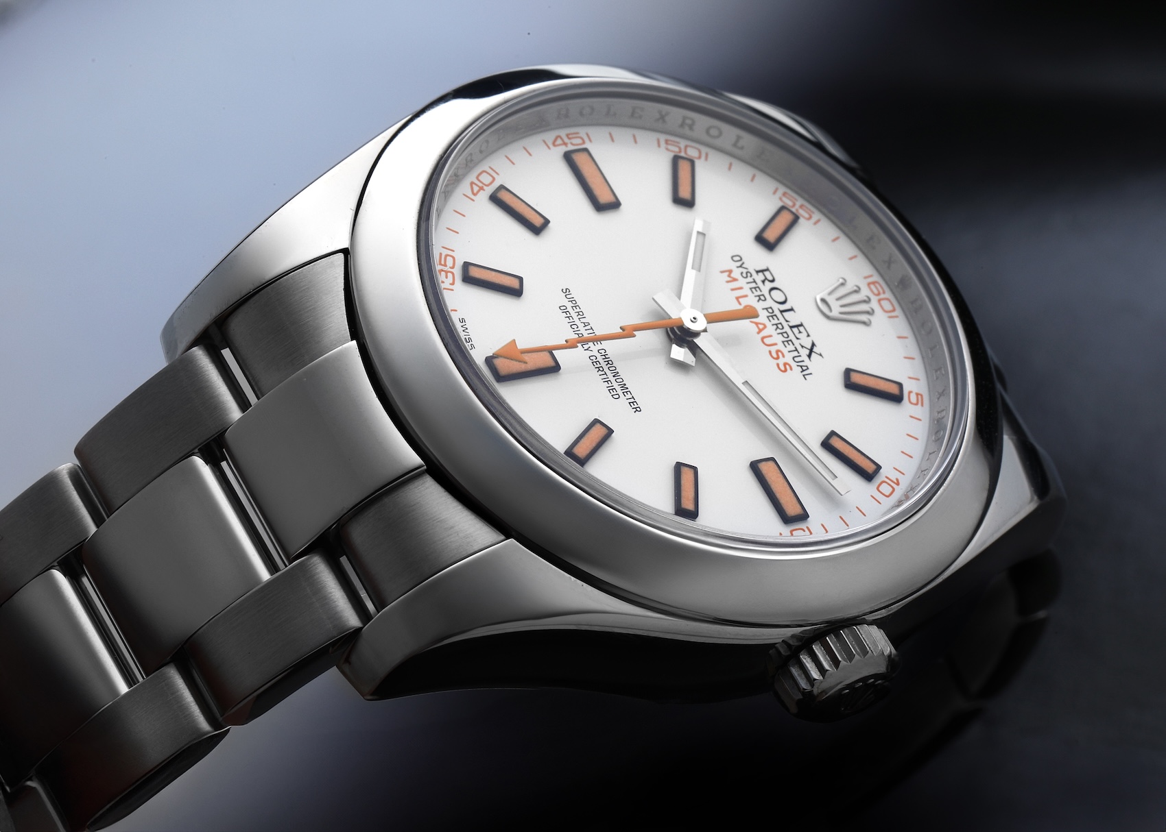 Rolex Milgauss Reference 116400 with white dial and orange hour markers.