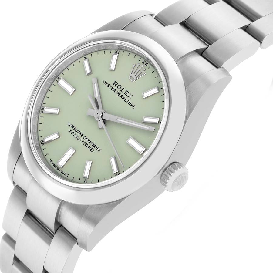 Angled close-up of the Rolex Oyster Perpetual 34 with the matte pistachio green dial and polished case side.