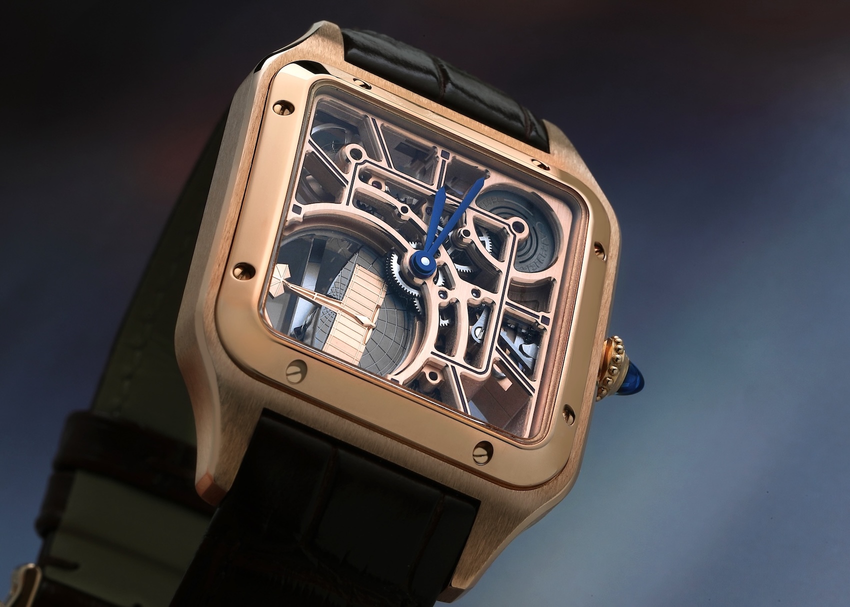 A rose gold Cartier Santos-Dumont skeleton watch showing the intricate mechanical movement, featuring a micro-rotor shaped like a vintage airplane.