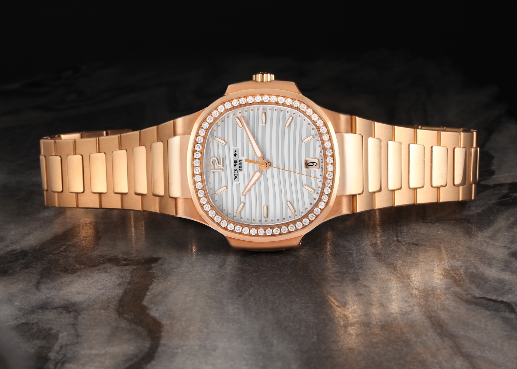 Patek Philippe Nautilus 7118/1200R-001 in rose gold featuring a diamond-set bezel and a silvery opaline dial.