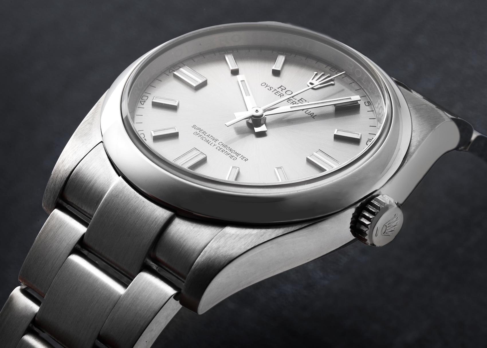 Macro shot of a stainless steel Rolex Oyster Perpetual 36 featuring a minimalist silver-grey dial and smooth bezel.