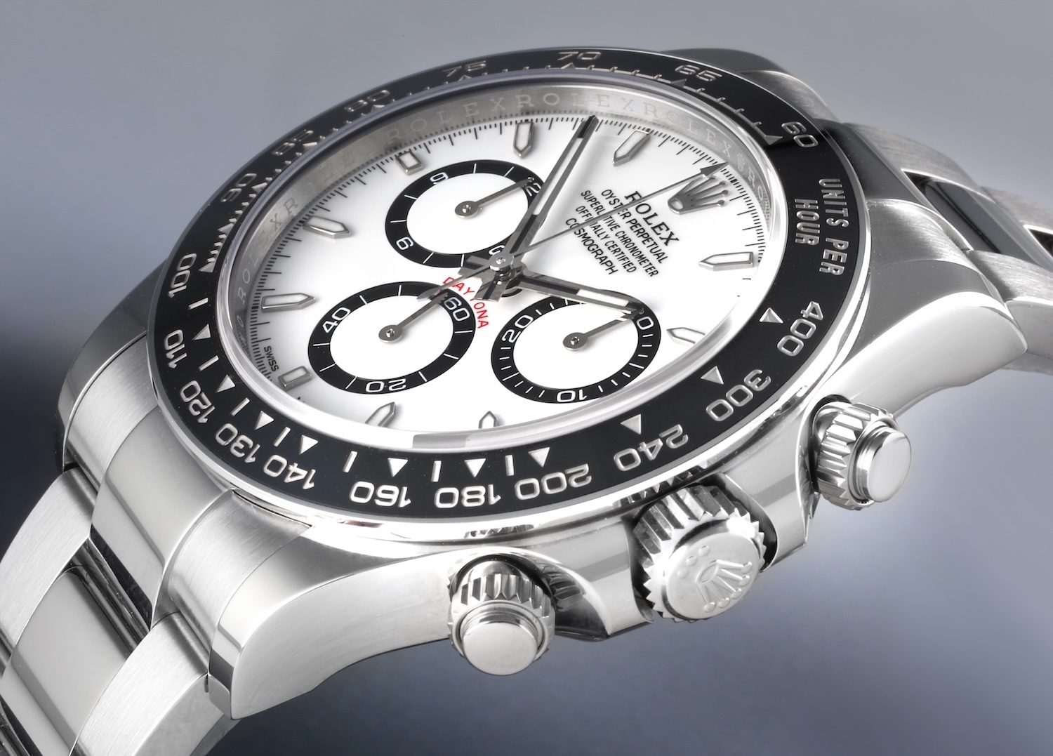 An angled view of the Rolex Cosmograph Daytona 126500 featuring a white dial with black chronograph rings and a black ceramic Cerachrom bezel.