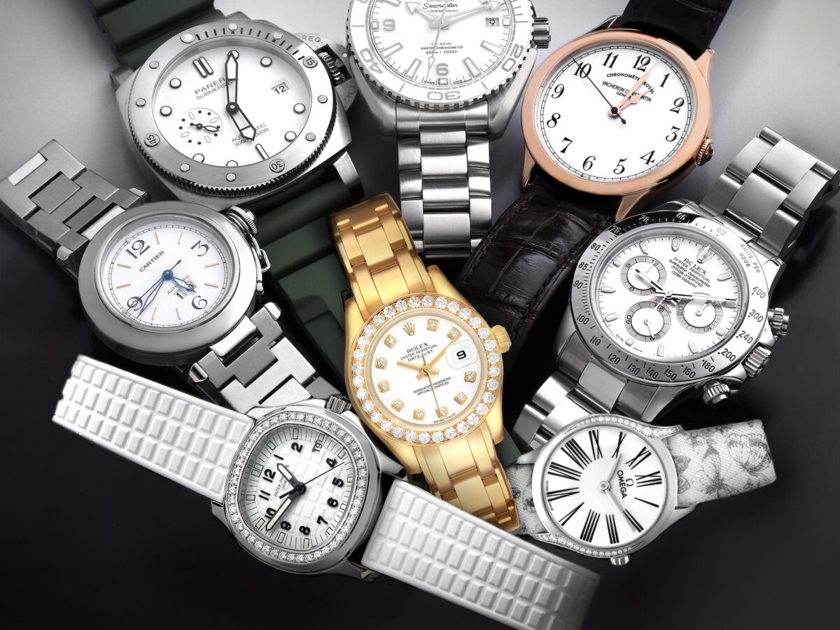 A curated collection of luxury white dial watches from Rolex, Patek Philippe, Omega, Cartier, and Panerai arranged in a circular layout on a dark background.