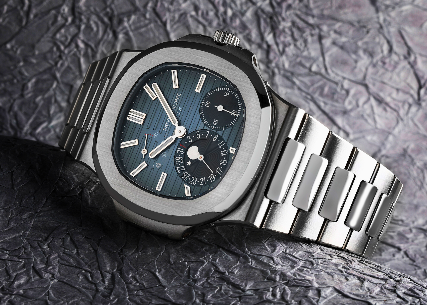 Macro view of the Patek Philippe Nautilus 5712/1A-001 Moonphase in steel, showing the asymmetrical dial layout.