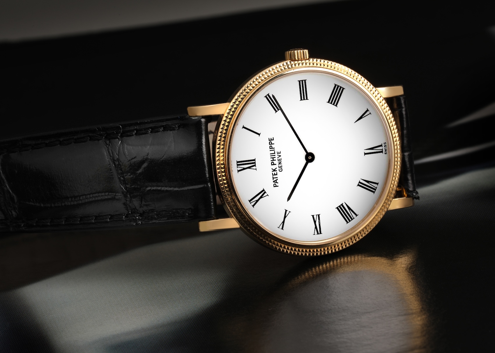 A macro profile shot of a Patek Philippe 5120J, focusing on the depth and precision of the hand-guilloché hobnail pattern on the bezel.