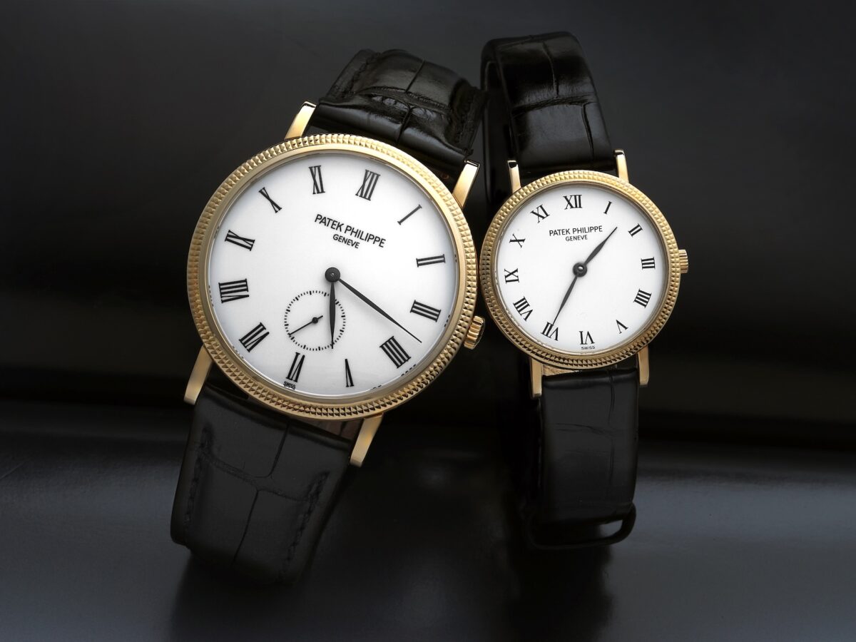 A side-by-side comparison of a larger men's Patek Philippe 5119 and a smaller ladies' 4819, showing the consistent use of the hobnail bezel across different sizes.