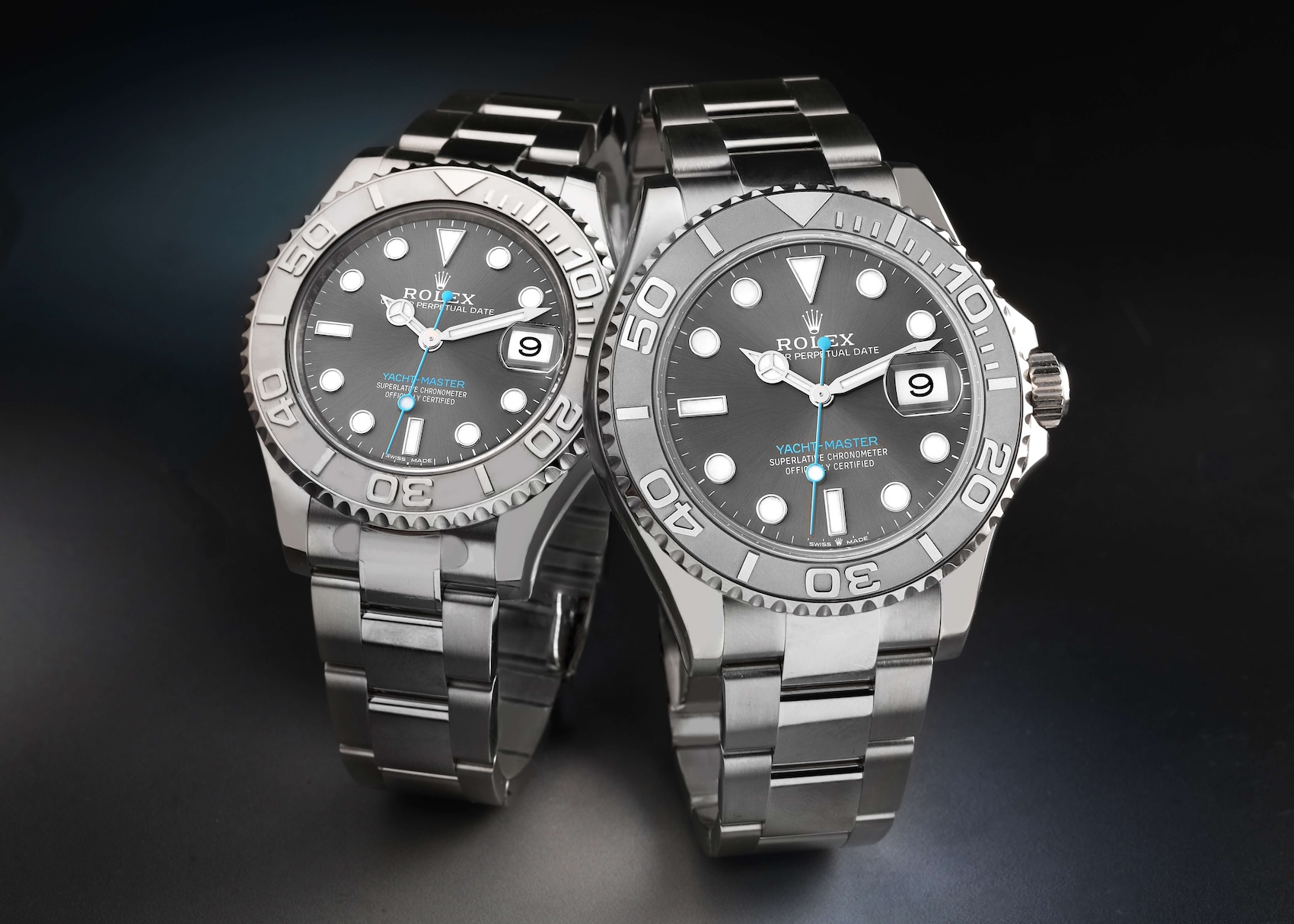 Pair of Rolex Yacht-Master watches in steel and platinum with dark rhodium dials and turquoise second hands.