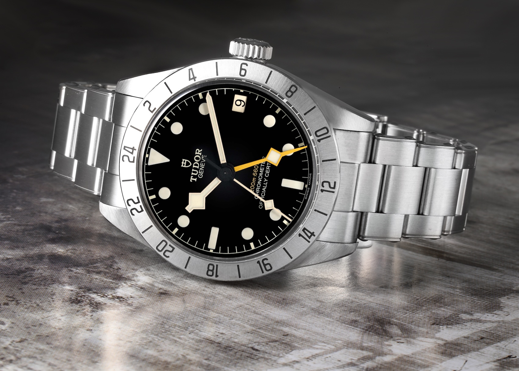 Tudor Black Bay Pro GMT featuring a fixed steel 24-hour bezel, black dial, and a prominent yellow GMT hand.