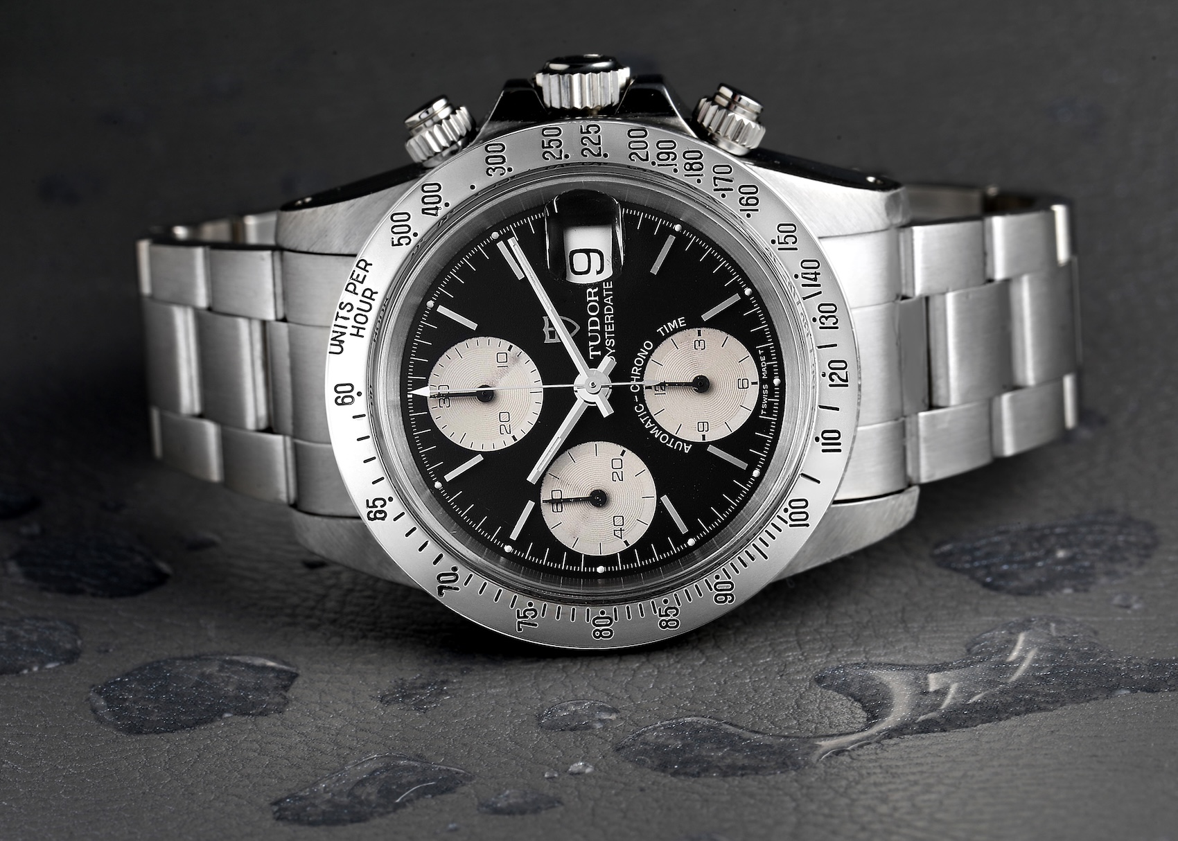 Tudor Prince Oysterdate "Big Block" Chronograph with a black dial, silver sub-dials, and a steel tachymeter bezel. 