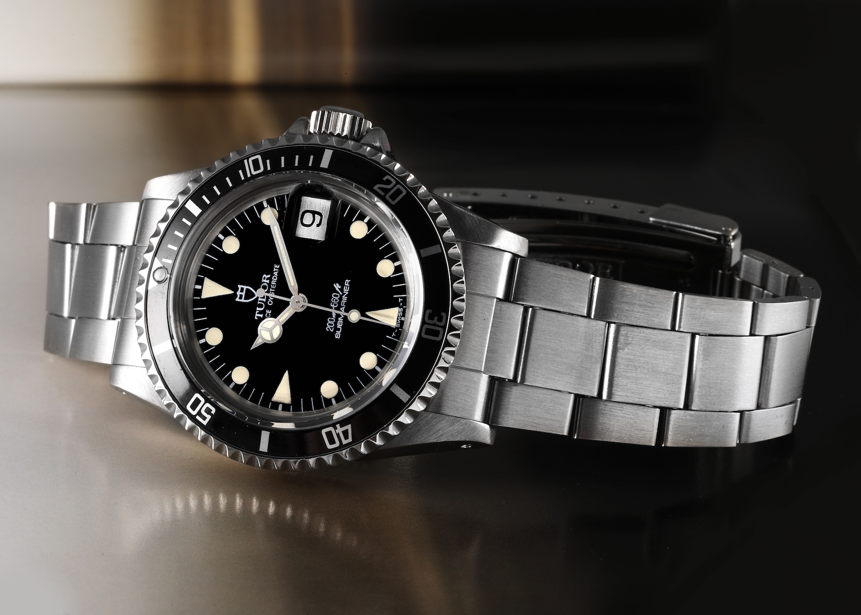 Vintage Tudor Submariner Prince Oysterdate Ref. 76100 with a black dial, "lollipop" hour hand, and steel Oyster bracelet. 