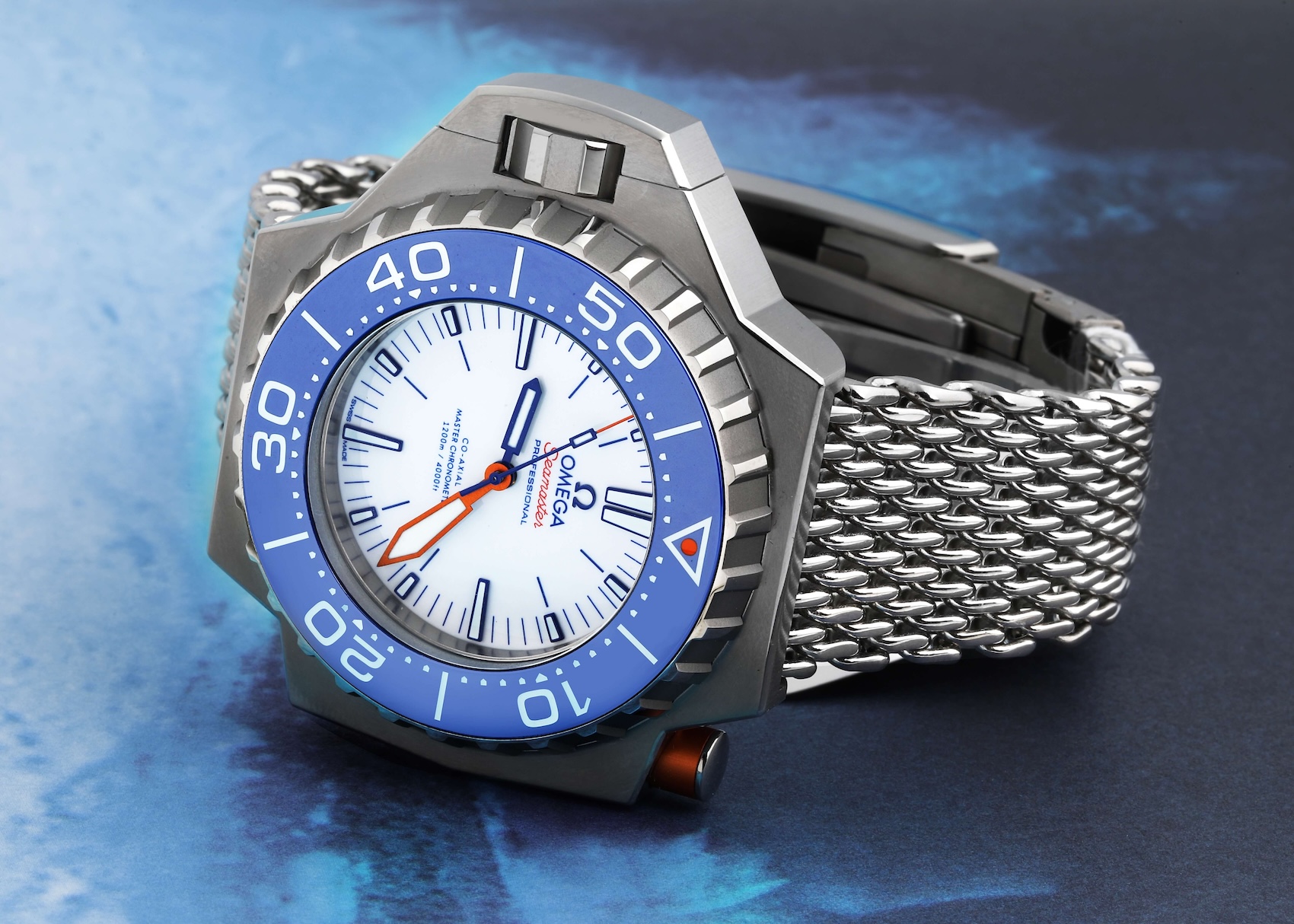Omega Seamaster Ploprof Titanium with mesh bracelet, blue bezel, and distinctive crown guard button.
