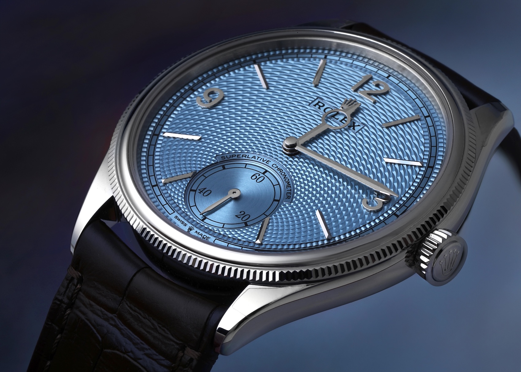  An angled close-up shot of the Rolex 1908 ice-blue dial, showing how the light reflects off the guilloché engraving radiating from the small seconds sub-dial at 6 o'clock.