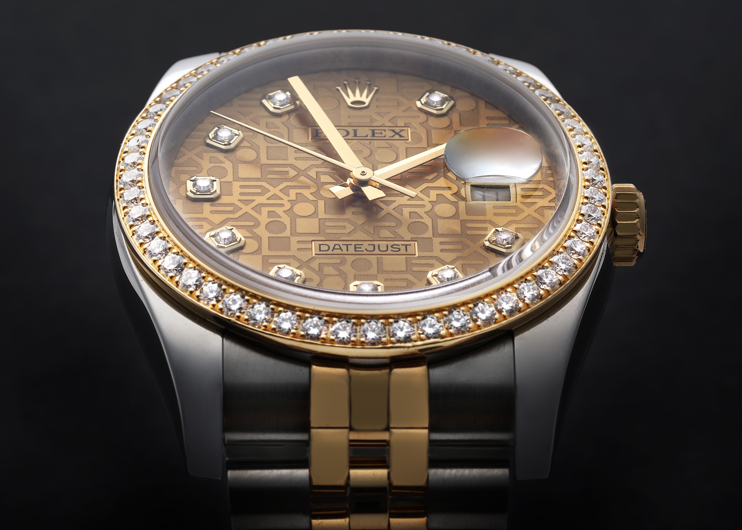 Close up of a Rolex Datejust with a Jubilee dial showcasing the glare-free Cyclops lens with anti-reflective coating.