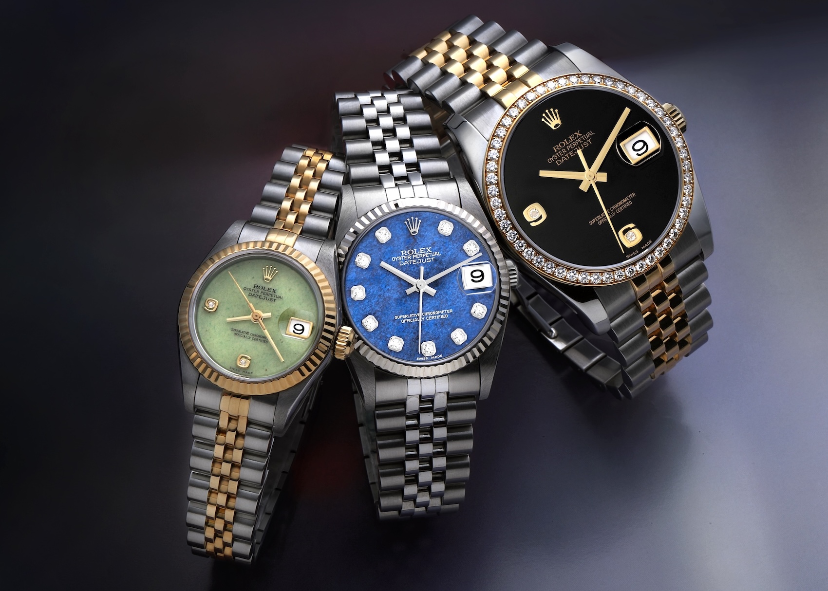 A trio of Rolex Datejust watches featuring exotic stone dials in jadeite, sodalite, and onyx.