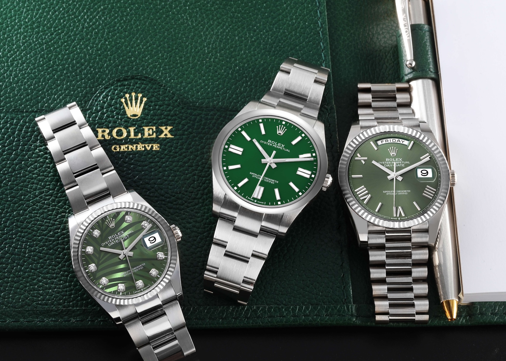 A stunning trio of green-dial Rolex Datejust and Day-Date watches, representing a large inventory of pre-owned timepieces.